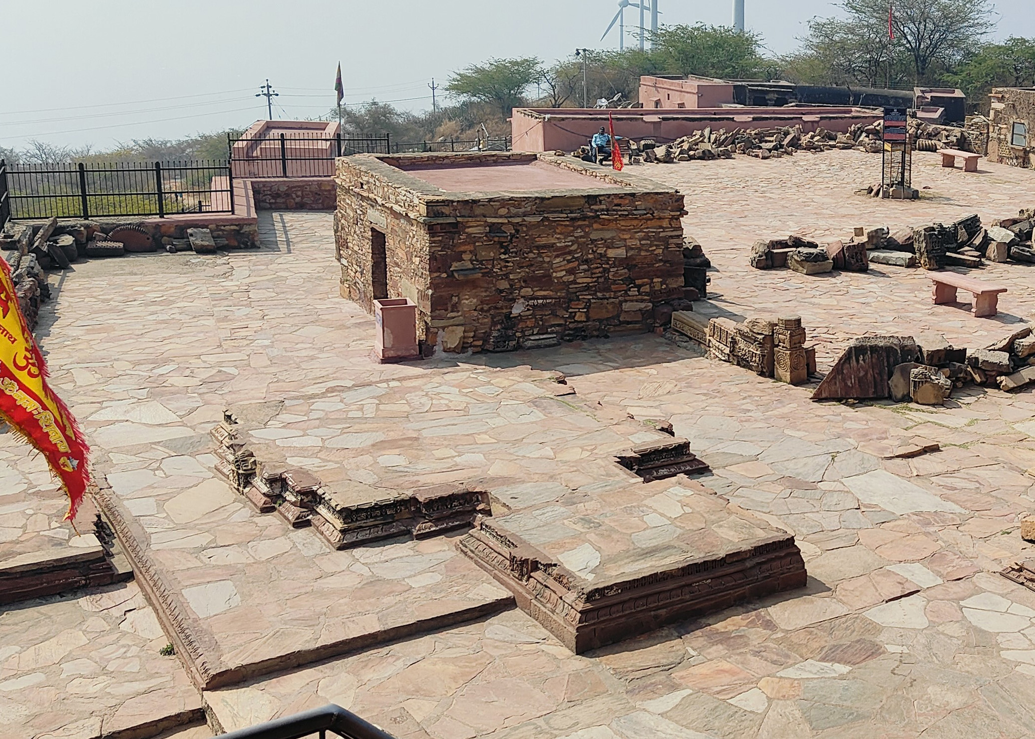 Image 2: In the 10th and 11th centuries, Harsha Hill saw the construction of about a dozen subsidiary shrines. Architectural fragments evidence the dedication of these shrines to various Brahmanical deities. Unlike a Panchayatan temple or a planned temple complex, these sub-shrines' irregular placement and size proportions suggest randomness and unplanned construction over an extended period of time. They exhibit a variety of pitha, usually corresponding to the Maha-Maru styles, but some of them also exhibit Maha-Gurjara features.