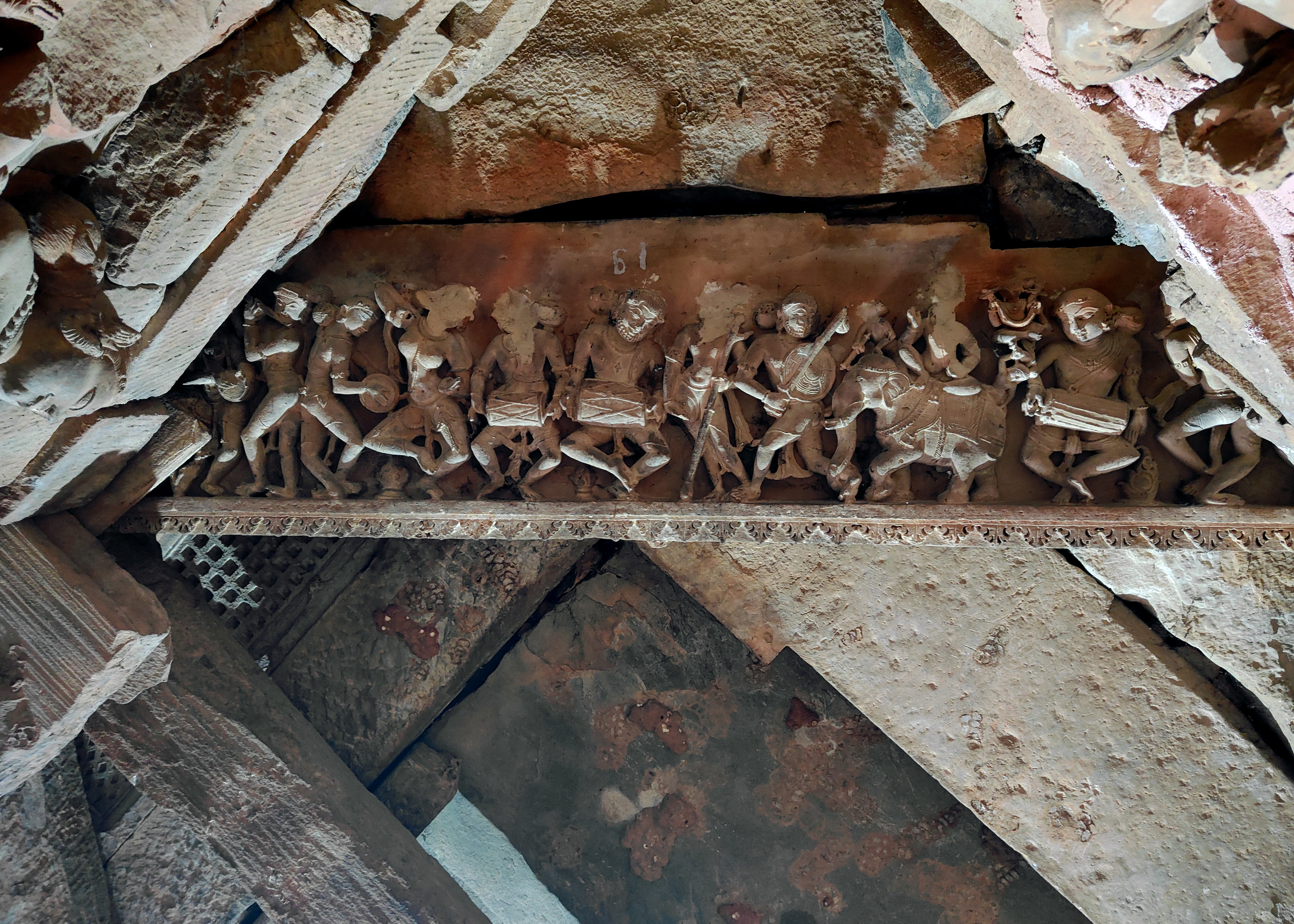 Image 5: In the frieze of the drumming and dancing gods are Indra, seated on his elephant Airavata; a warrior holding a sword and shield; and an Apsara. 