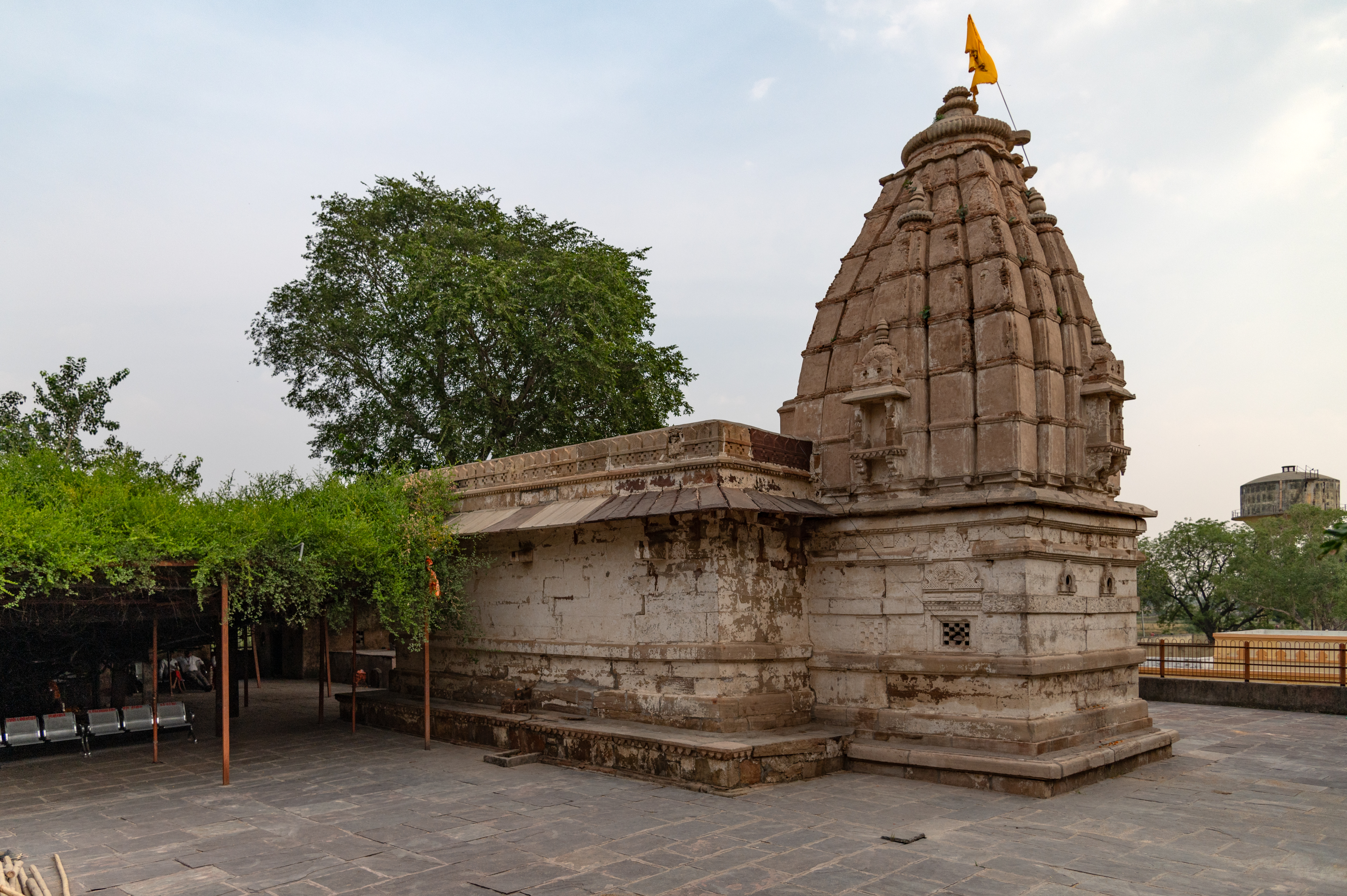  View of the main temple structure from the southwest. The garbhagriha, unlike the mandapa exterior, shows some decoration on its façade. The garbhagriha stands on base mouldings with jaali (checkered) windows and chaitya arches. It has a simple latina type shikhara (spire) with niches topped by udgama pediments (pediment with interconnected chaitya dormers) which look like miniature shikaras.