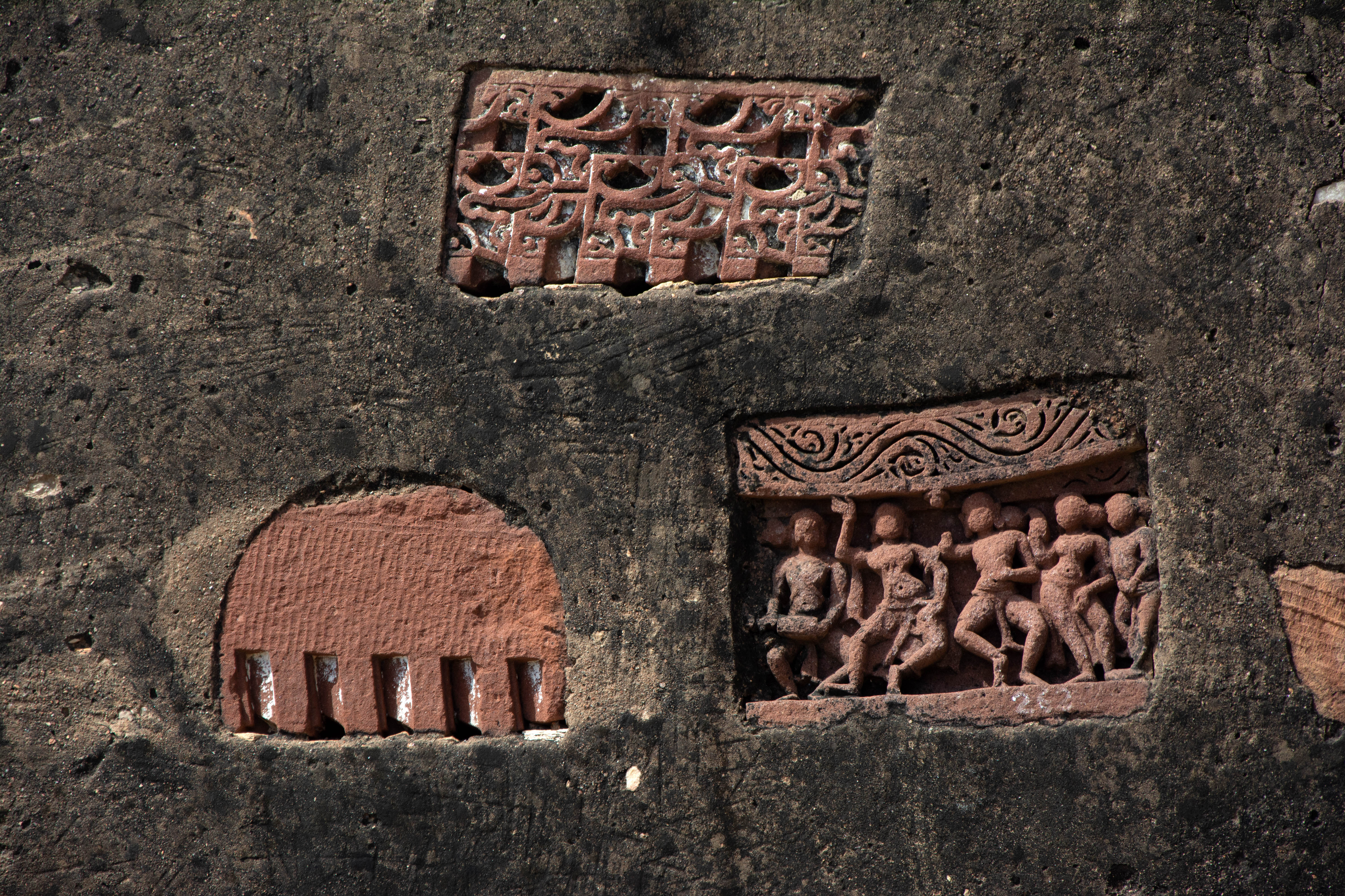 Architectural fragments affixed on a late medieval structure on Harsha Hill. Loose fragments include remains of a superstructure, a panel depicting dancing figures, etc.