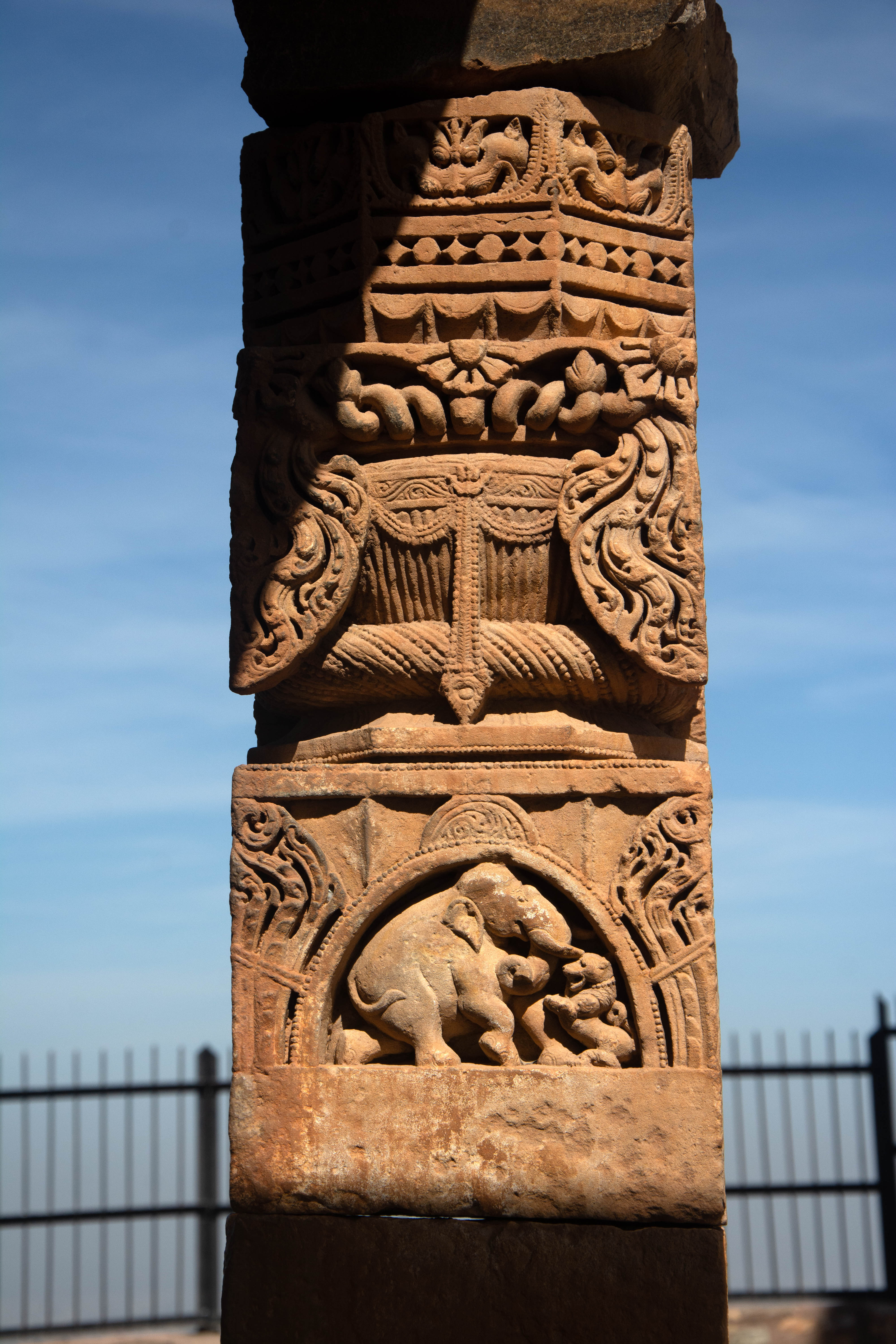 The ghata-pallava pillar, showcasing remarkable craftsmanship, depicts a lion and an elephant engaged in combat.