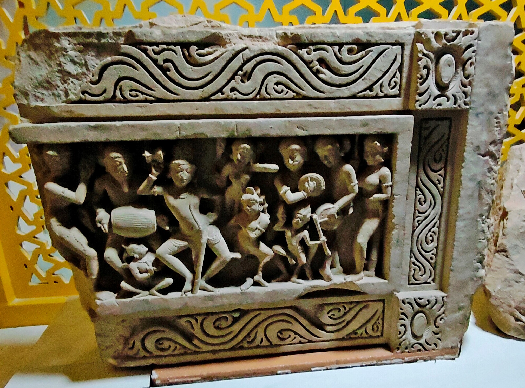 A lost Shaiva temple on Harsha Hill may have once housed the panel depicting Shiva in his dancing form, Natesha, at its ceiling. The Government Museum in Sikar now houses it. Various dancers and musicians surround Natesha in the depiction. Natesha gracefully holds a damru in his right hand and likely a significantly damaged trident in his left.