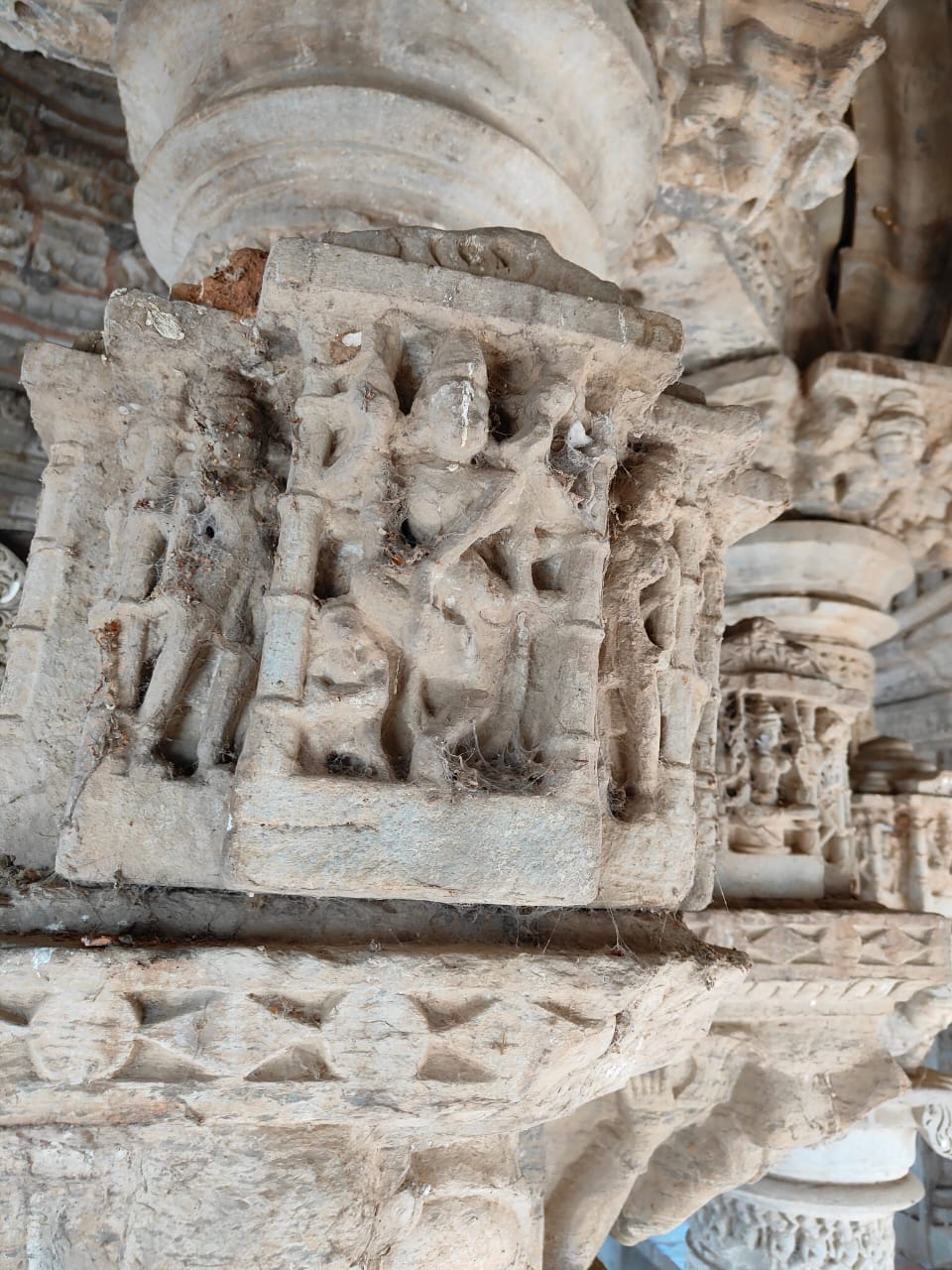 Image 10: Representation of a dancing Shiva or Natesha, on the niche of the cornice above the pillar of the mandapa of the Bisaldeo Temple.