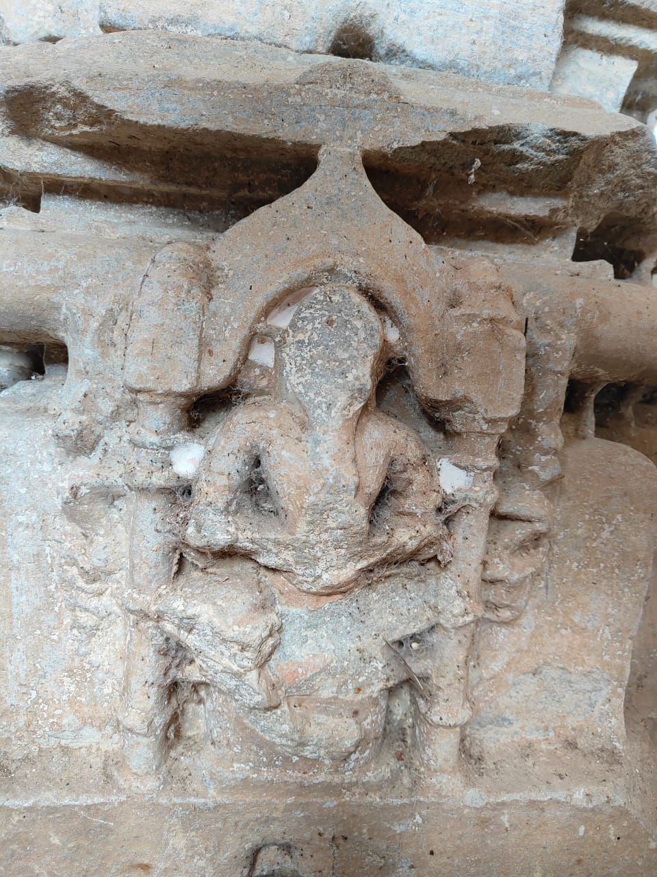 Image 11: A cross-legged ascetic is carved in the kumbha niche of the pillar in the mandapa of the Bisaldeo Temple.