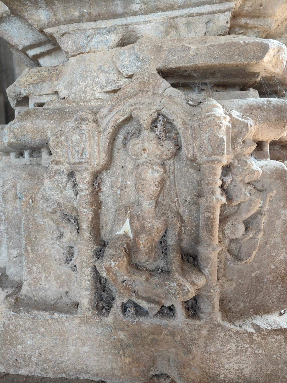 Image 12: A cross-legged ascetic is carved in the kumbha niche of the pillar in the mandapa of the Bisaldeo Temple.