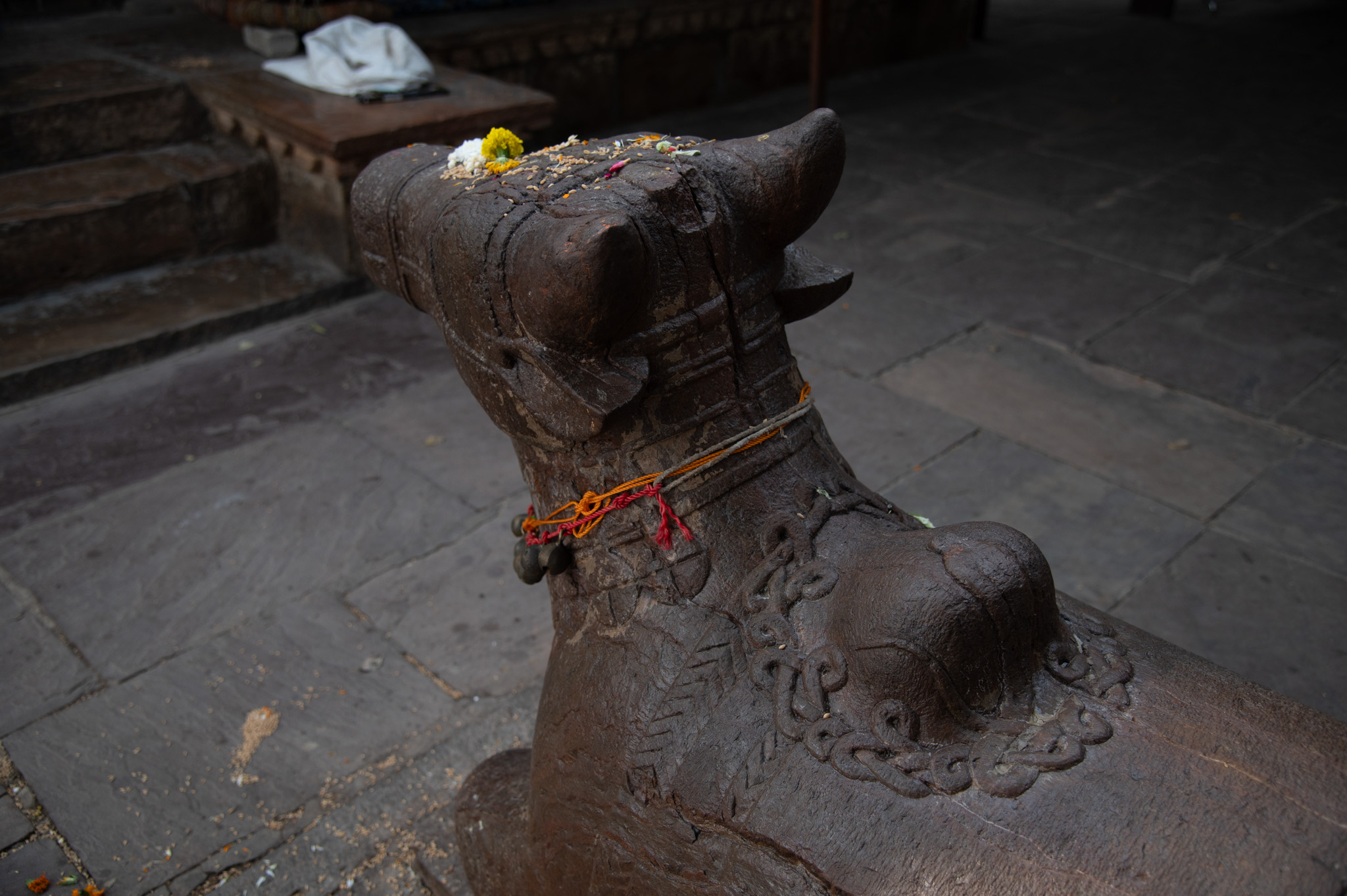 The magnificently decorated sculpture of Nandi, positioned in front of the platform and orientated towards the mulaprasada (main temple), is truly impressive. Particularly notable is the hump of Nandi, which is adorned with an intricately coiled serpent that gracefully encircles the hump, adding to the sculpture's beauty.