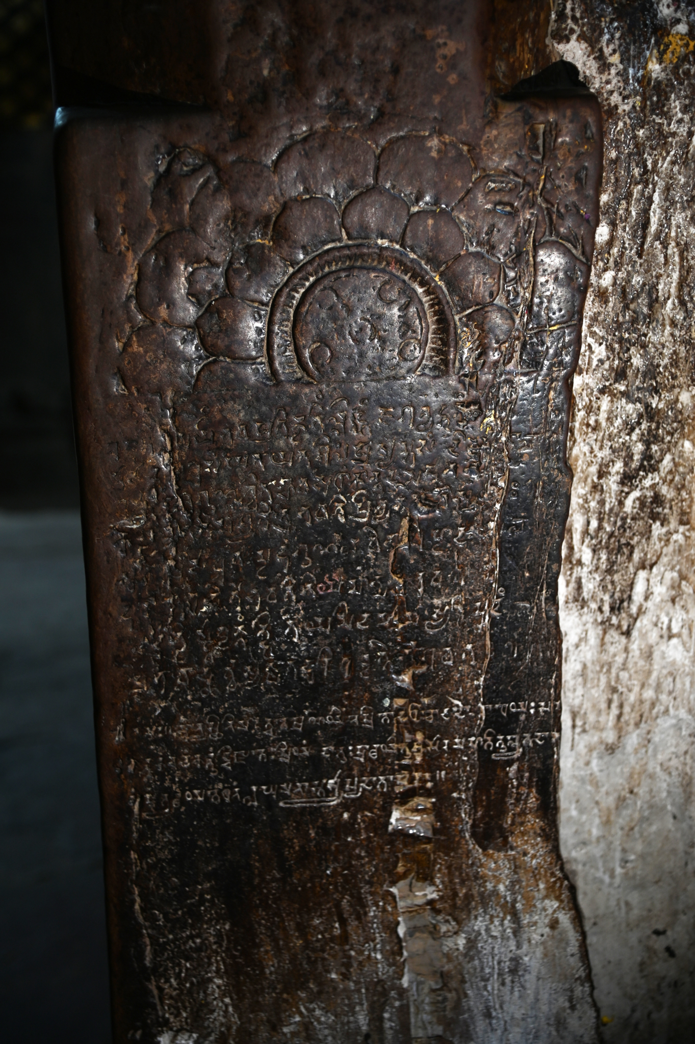 The pillar on the north end of the antarala has an inscription in Brahmi script, with Gupta letters playing an important role in dating the temple's foundation. A full-blown lotus sits beneath the inscription. However, the pillar's surface has deteriorated, and the letters are not clear, making it difficult to discern the meaning of the inscription. Nevertheless, one can observe that the inscription comprises twelve lines. The last three lines appear distinct in their letters and style compared to the upper part of the inscription. The inscription's first three lines discuss the Shiva linga and the temple.