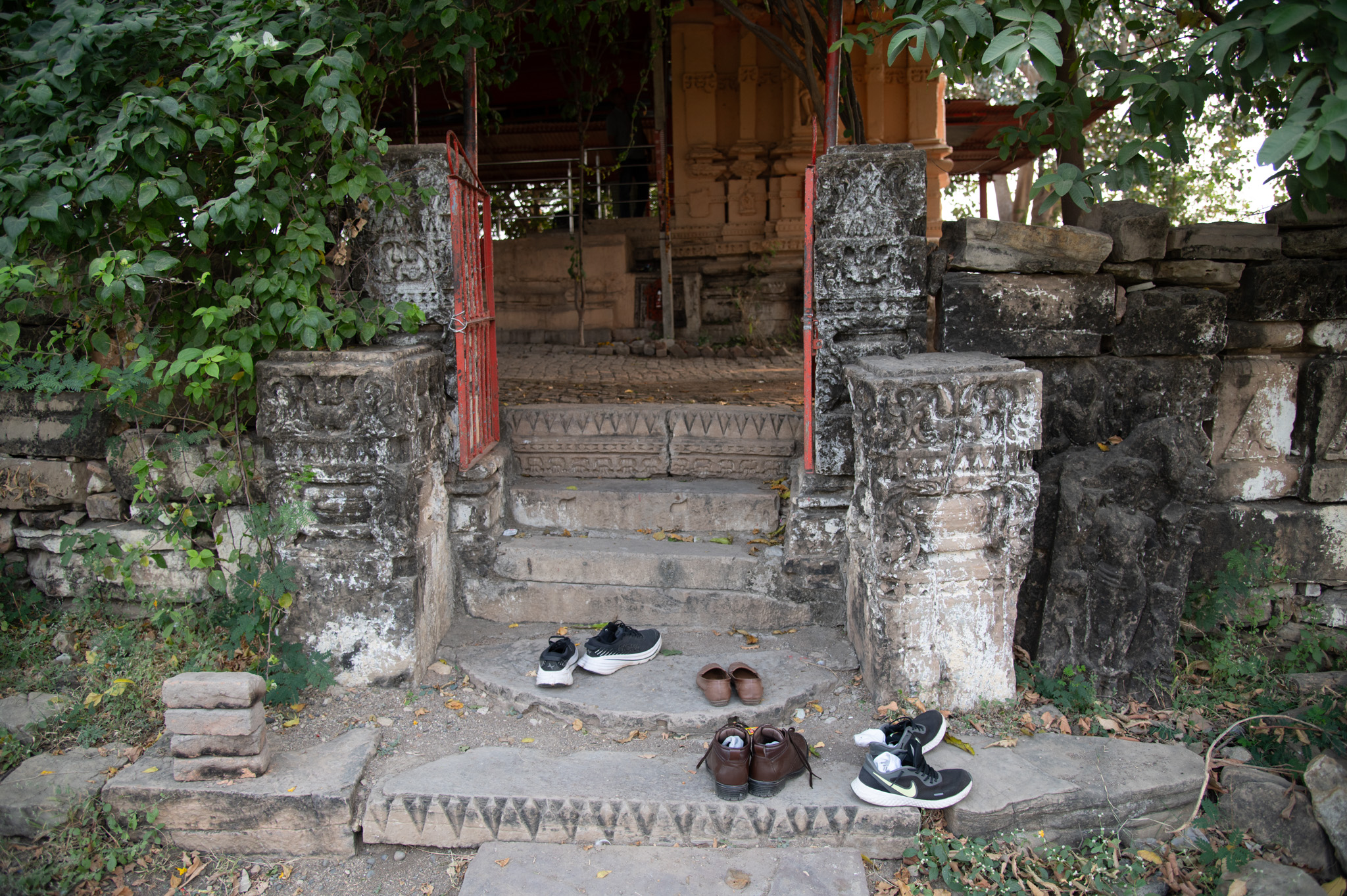 Staircases through the present entrance (from the south) lead to the temple complex. Pillars, one on each side, flank the stairs, carved with purnaghata kalasha (vase of plenty) and kirtimukha (face of glory). Tight-fitted bricks make up the present floor of the temple complex.