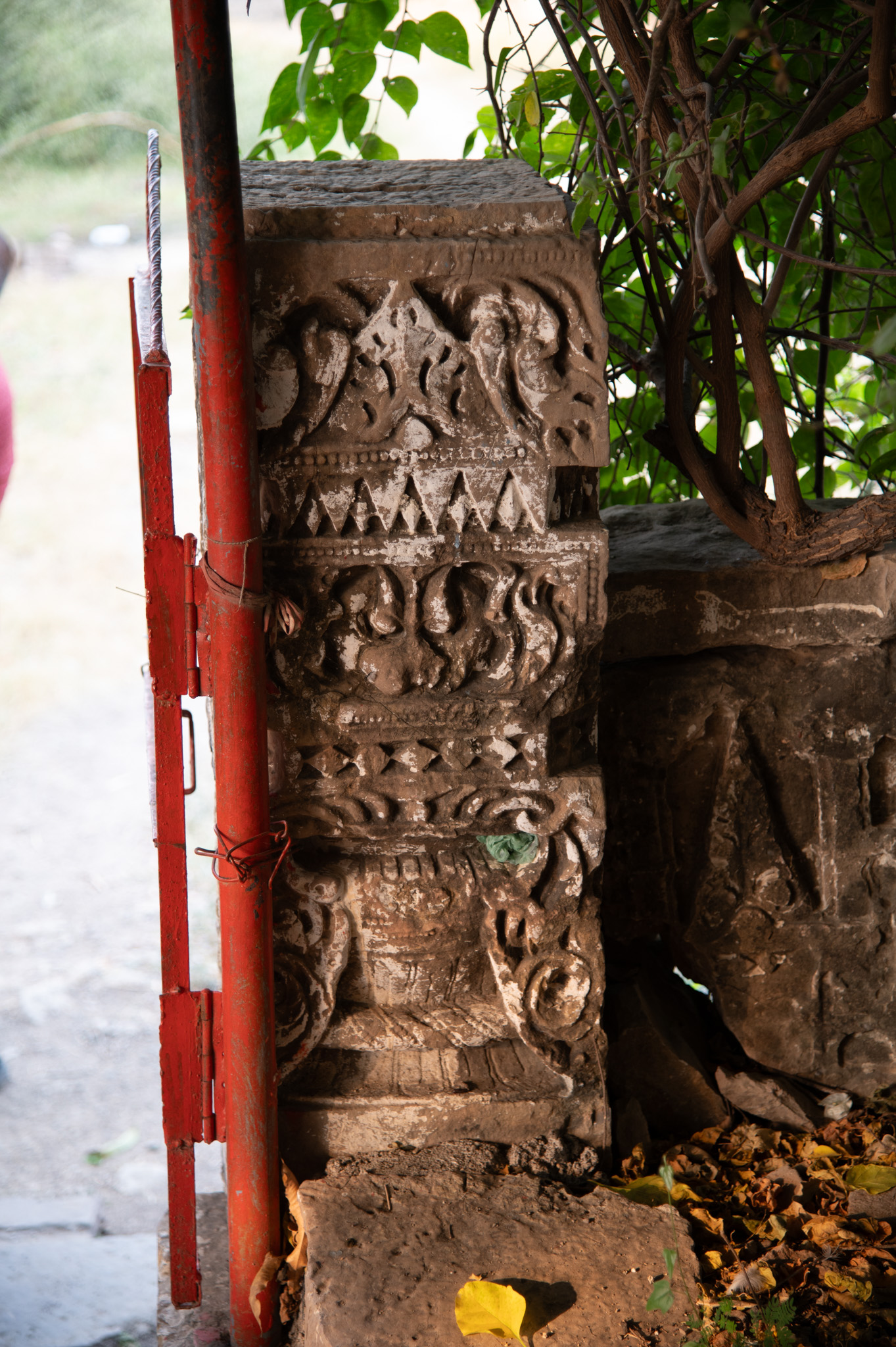 Details of the pillar (from within the temple) flanking the staircase leading to the temple are presented. Regardless of regional stylistic variations, temples typically depict the auspicious purnaghata kalasha on their pillars. The carvings above this kalasha feature a manibandha, topped by a kirtimukha, and a triangular leaf motif at the apex.