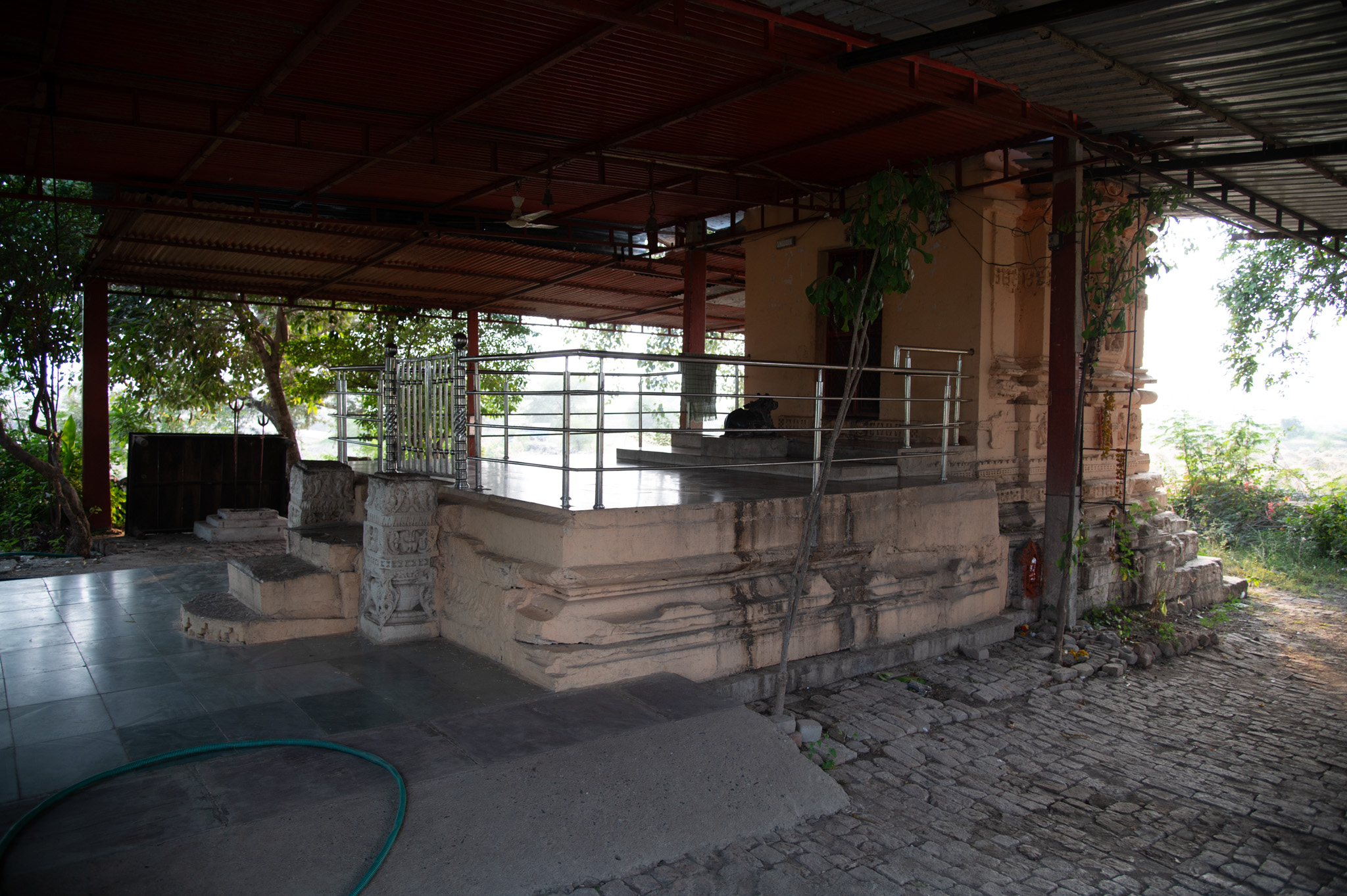 The surviving shrine, known as the Mahakal Temple, presently consists of an open mandapa with modern steel railing, situated in front of the original garbhagriha. Steps flanked by carved pillars lead to the temple. The old vedibandha, refloored with modern tiles, reveals the old base of the mandapa. There is a nandi (the bull vehicle of Shiva) in the mandapa, facing the main sanctum.