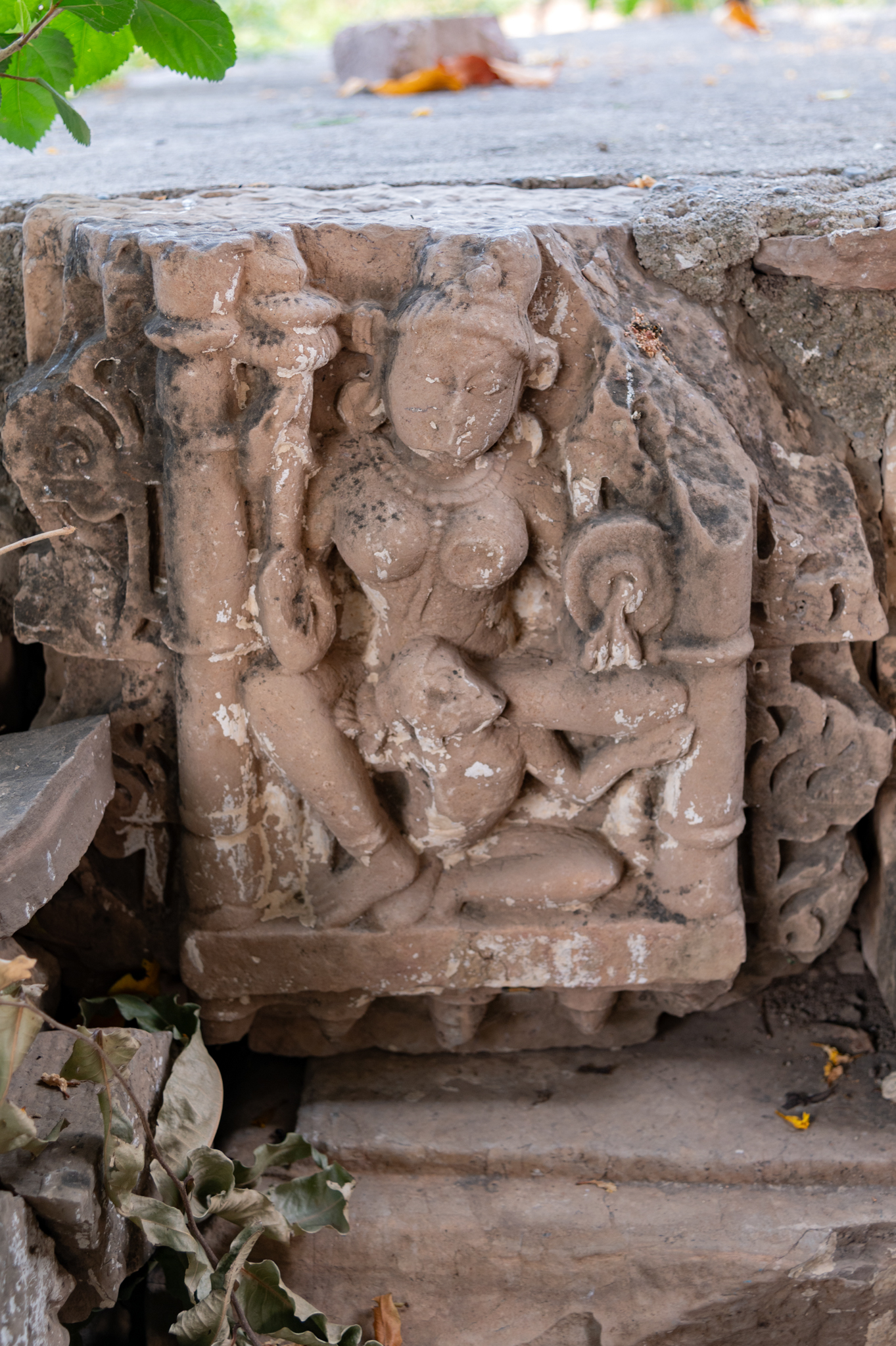 A sculpture of Vaishnavi, seated on a garuda, is visible on the left side corner of the subsidiary shrine (II) in front of the Mahakal shrine. With one of her upper hands damaged, the four-armed Vaishnavi holds a shankha, gada, and chakra in her hands.