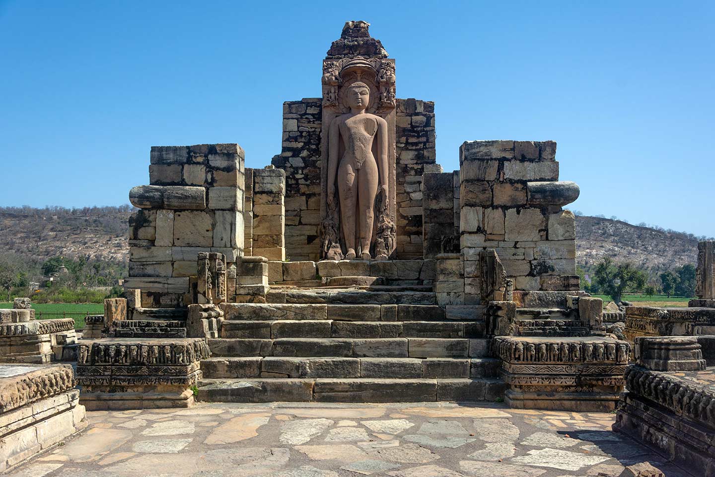 Image 5: The ruinous Naugaza Shantinatha temple houses the colossal Jina Tirthankara Shantinatha image in its garbhagriha (sanctum sanctorum). Only the exterior plinths of this temple have survived. These are decorated with elephant friezes and geometric patterns.