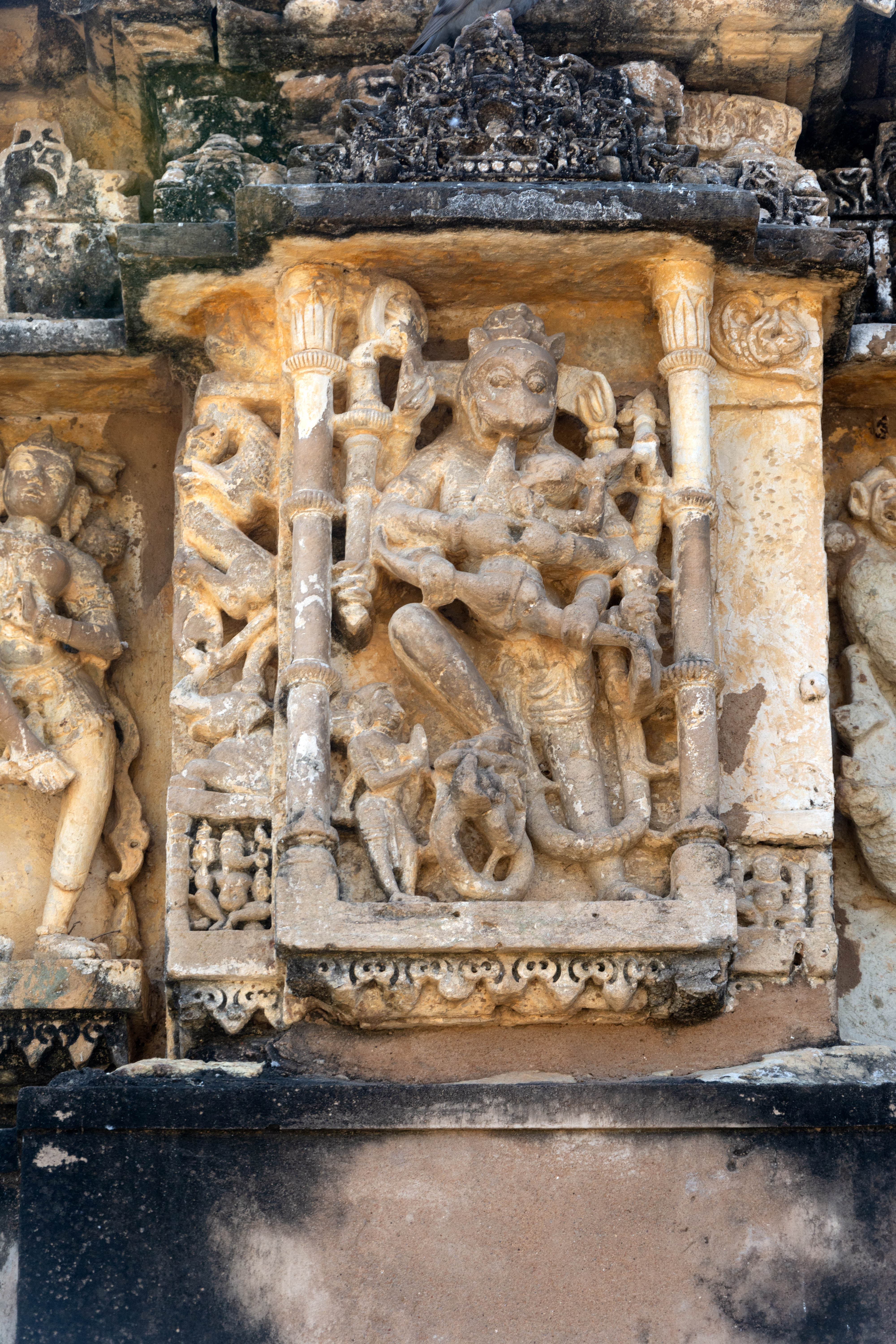 Image 1: The bhadra (central projection) has a depiction of Narasimha killing the demon, Hiranyakashipu. The recesses have vyala and mithuna/maithuna figures.