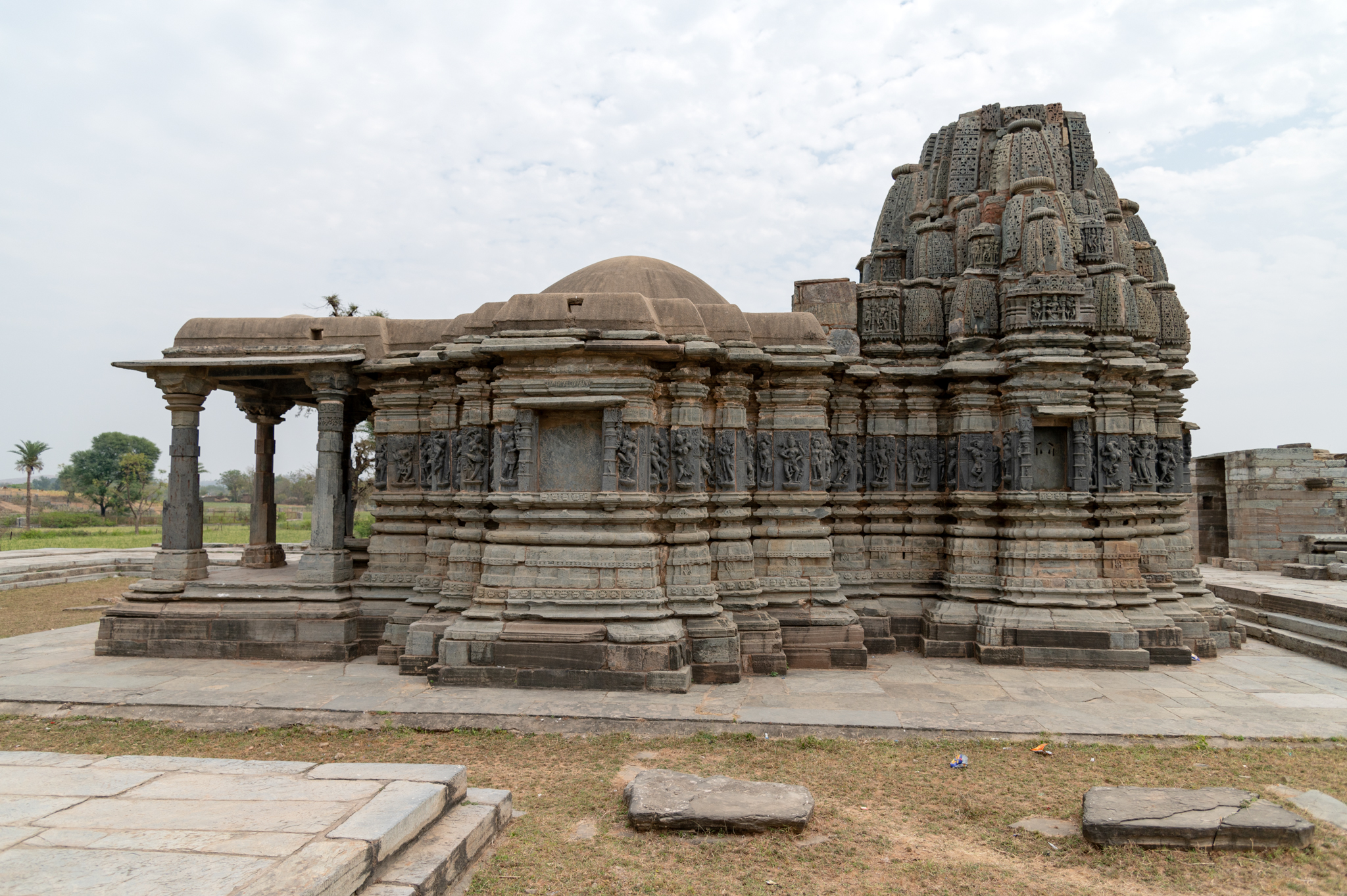 Seen here is the north-facing principal entrance of the Jain temple complex. A flight of steps leads to the temple's elevated platform. The entrance is marked by pillar remains on four corners, which must have supported a semi-open pavilion connected to the temple complex's raised platform.