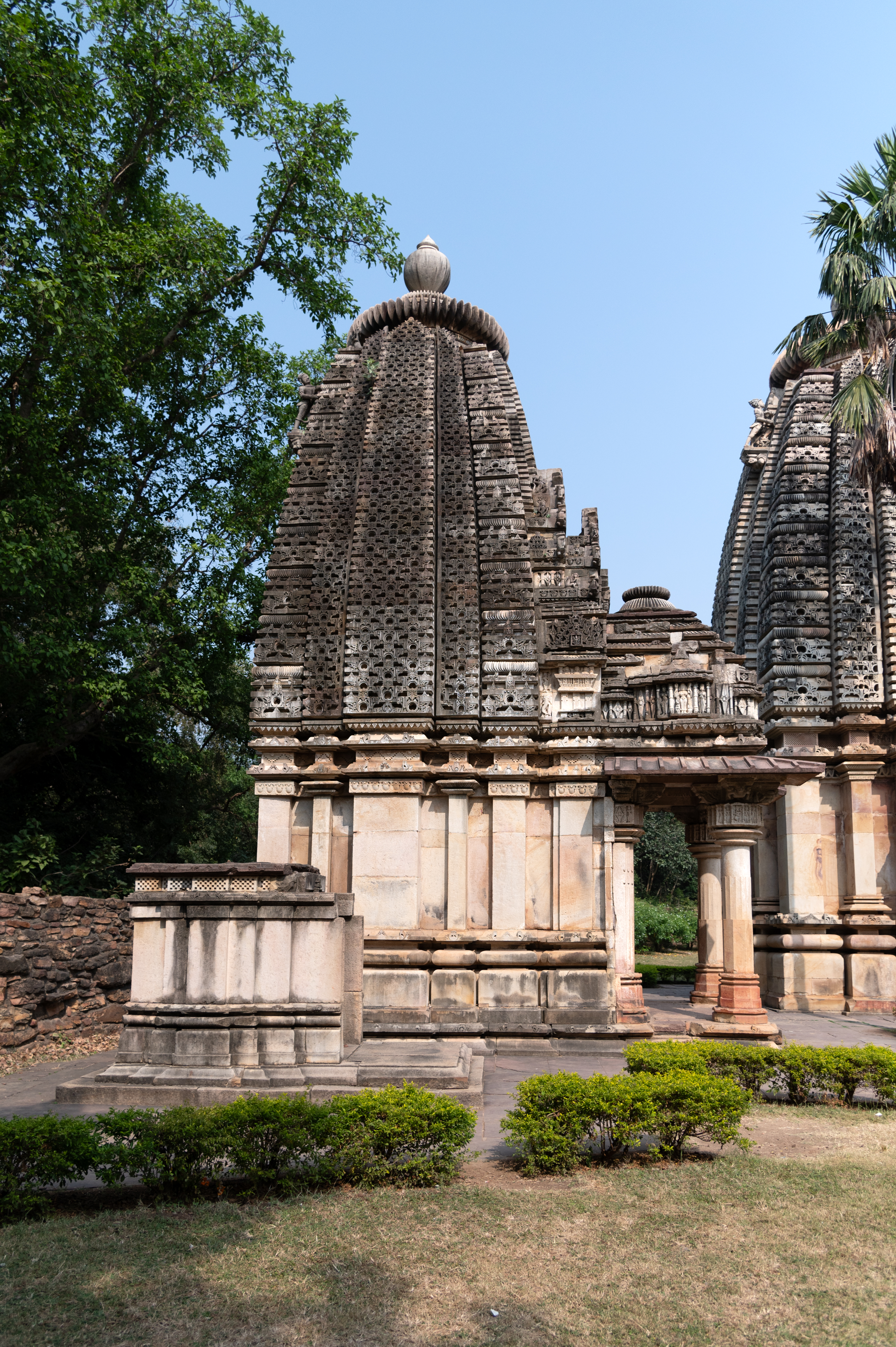  The Mahishasuramardini Temple has a pitha (a small platform) and well-defined base mouldings, with a plain jangha (wall) adorned with only a decorative band at its upper part. The varandika (moulded parapet) supports the latina shikhara (mono-spired) with navabhumis (nine tiers). The shikhara (superstructure) is intricately carved with the jala of chaitya arches, and at its apex, it features amalasaraka a segmented or notched stone disk), chandrika (are a series of amalaka discs), another amalasaraka topped by a kalasha (pitcher shaped finial).