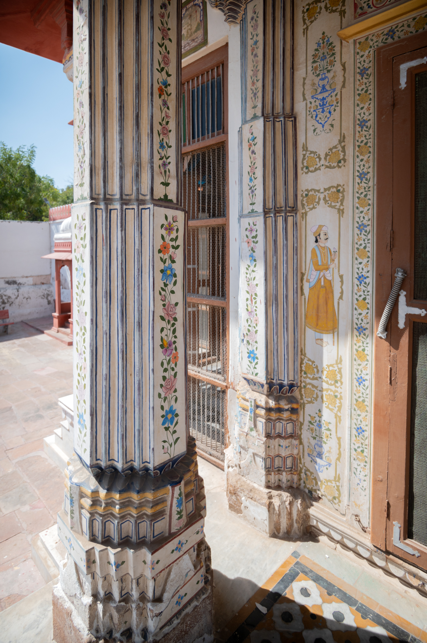 Details of the pillars, pilaster and the small strip of wall flanking the principal entrance of the Bhandasar Temple. The small vertical wall space flanking the entrance depicts paintings of doorkeepers.