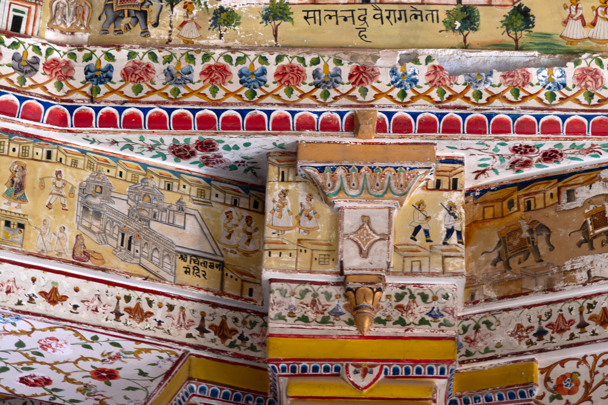 The horizontal lowest band of the ceiling of the mandapa (pillared hall) of Bhandasar Temple is a painting of the famous Chintamani Temple of Bikaner. Drawn as a two-dimensional object, the painting portrays the temple structure as 2D. The face of the pillar capital in the image has a Shrivatsa symbol, one of the eight auspicious Jain symbols.