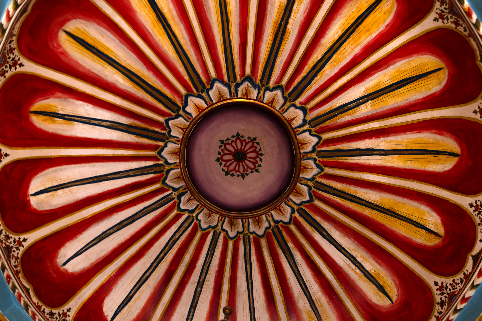 Painted floral medallion on the ceiling of the mandapa (pillared hall) of the Adinatha Temple. Compared to other paintings on the ceiling, this is a different pattern of a large medallion. Small floral ornamentation patterns are plenty, but large medallions are uncommon.