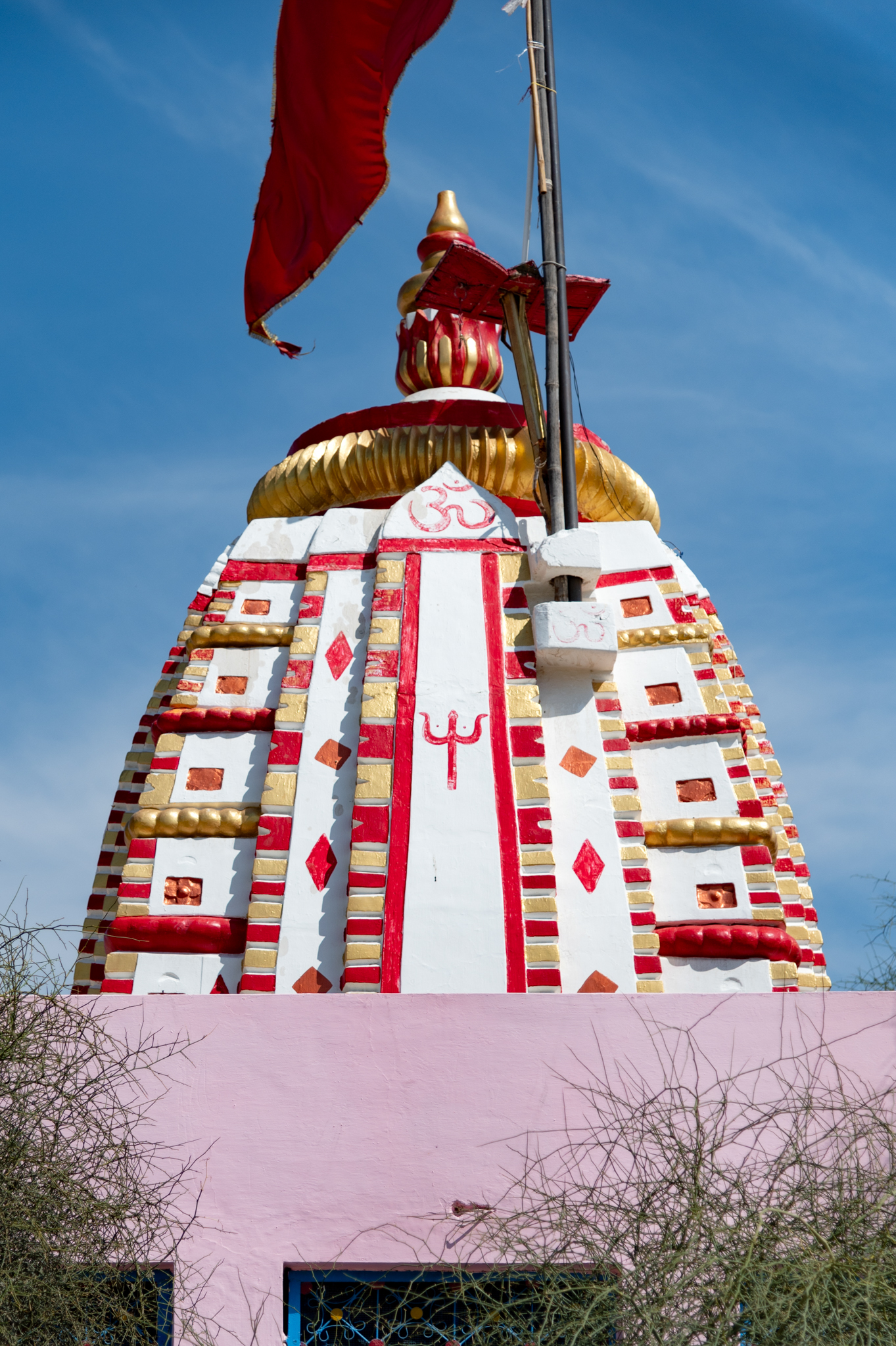 Seen here is the back, west-facing elevation of the shikara (superstructure) of the Suswani Mata Temple. The shikhara is composed of a main central band flanked by two slender bands on either side. Originally built in stone, it has been painted later.