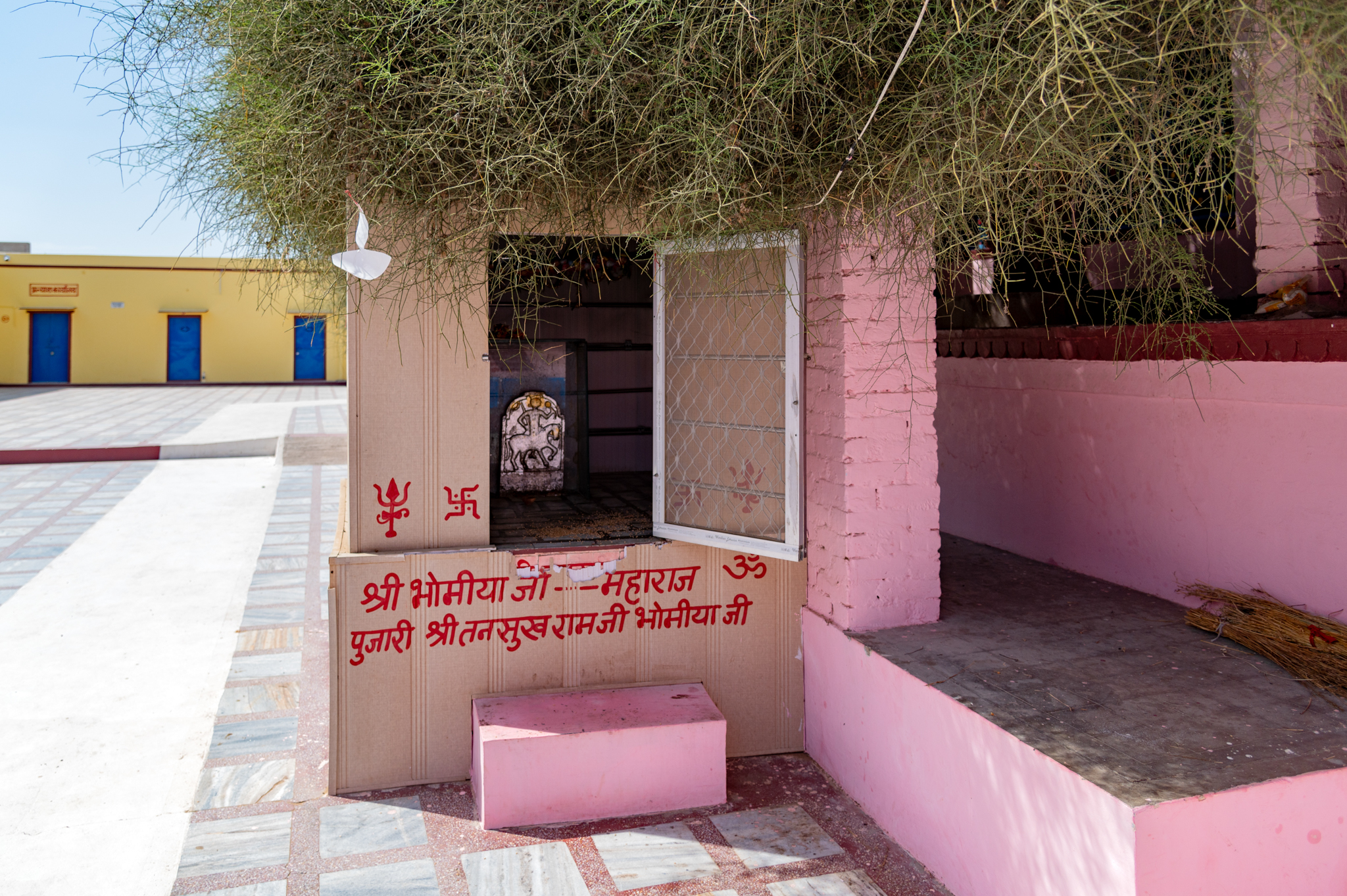 A side shrine of the Bhomiya Maharaja on the premises of the Suswani Mata Temple next to the sacred Kera tree. The Kera tree is believed to be the spot where Suswani Ma manifested herself and eventually stayed at the location of the present-day temple.