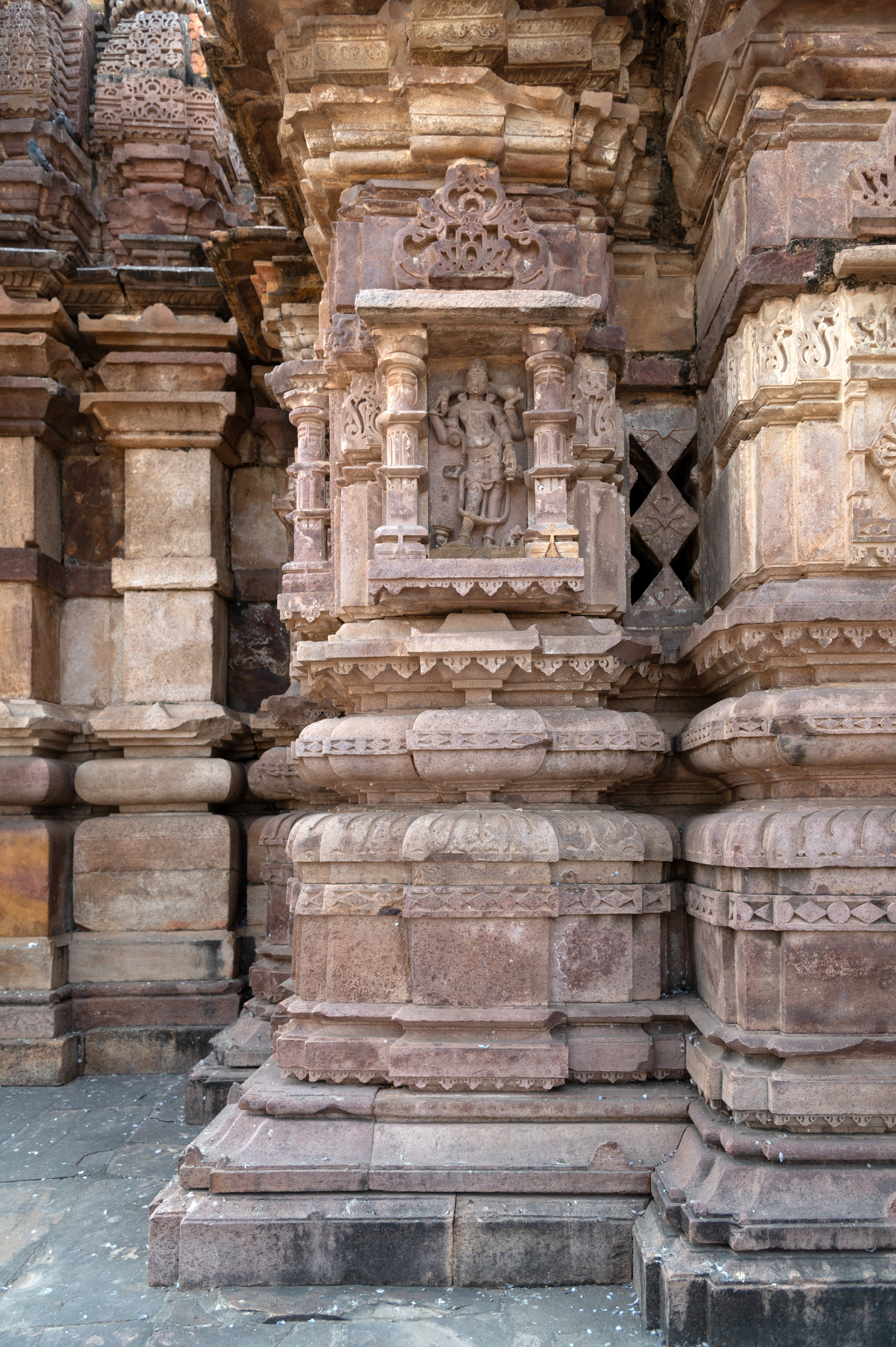 The Mahakal Temple mandapa (pillared hall) has depictions of dikapalas (deities for cardinal directions). Kubera is one of them who is portrayed with four arms. He holds a money bag in his upper hand, a kamandalu (water pot) in his lower left hand and a gada (mace) in his lower right hand. At the base of the niche, Kubera’s Mount Airavat is carved.