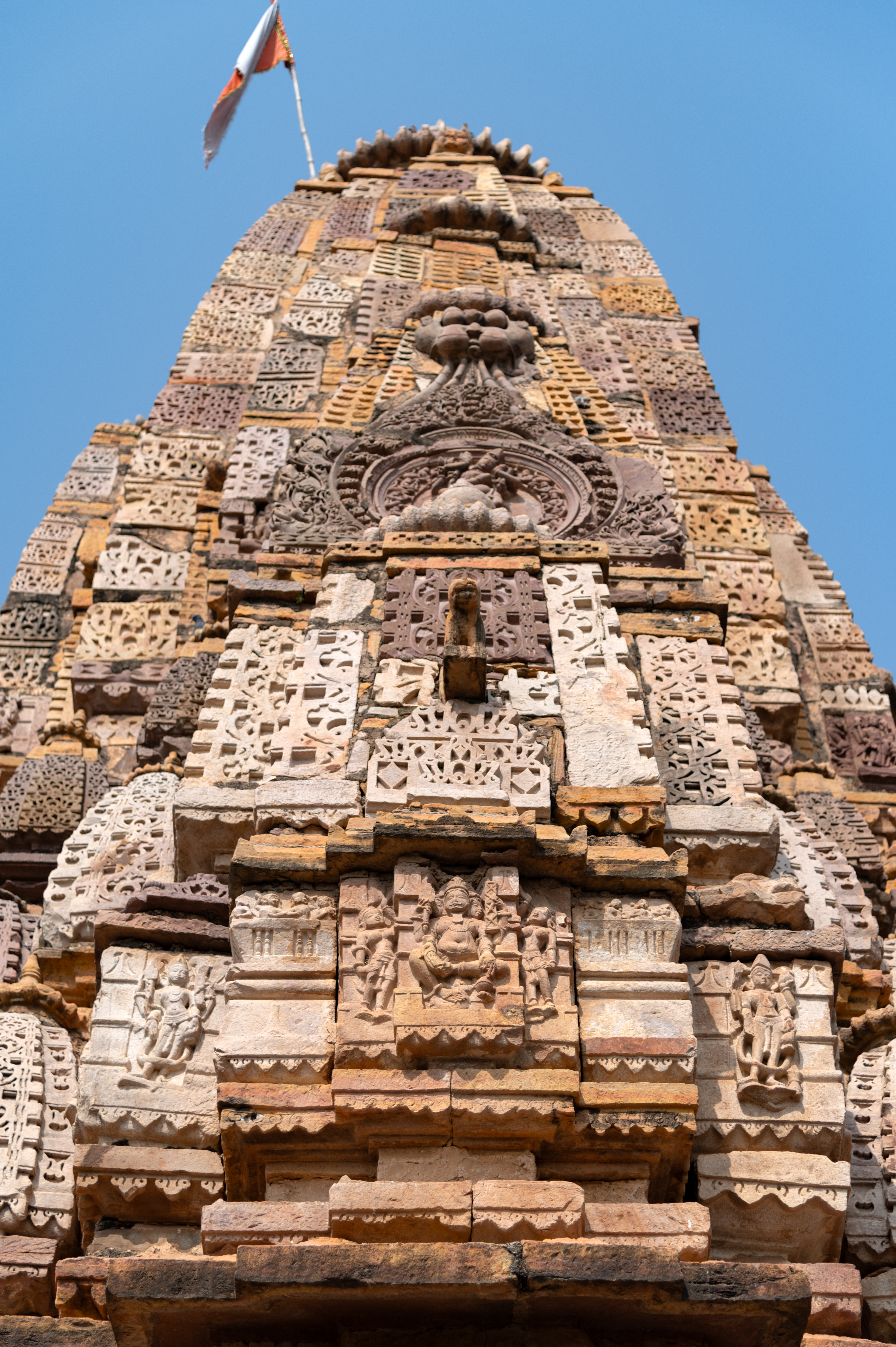 According to the Archaeological Survey of India (ASI), the Hazareshwar Temple is classified as being constructed in the Bhumija style. However, upon closer examination of the shikhara (superstructure), it is evident that it does not adhere strictly to the typical Bhumija style but rather exhibits a mixed style. The mulamanjari (principal spire), uruhshringas (subsidiary spires leaning against the principal spire), and kutas (miniature shrines) represent a feature of shekhari shikhara style, i.e., the central latina spires with rows of half spires added on either side. Pediments are present on all three sides, with surasenakas situated above them. Divinities such as Brahmani, Brahma and Shiva are carved on the pediments above the antarala and garbhagriha. Notably, the surasenaka features a stunning depiction of Natesha.