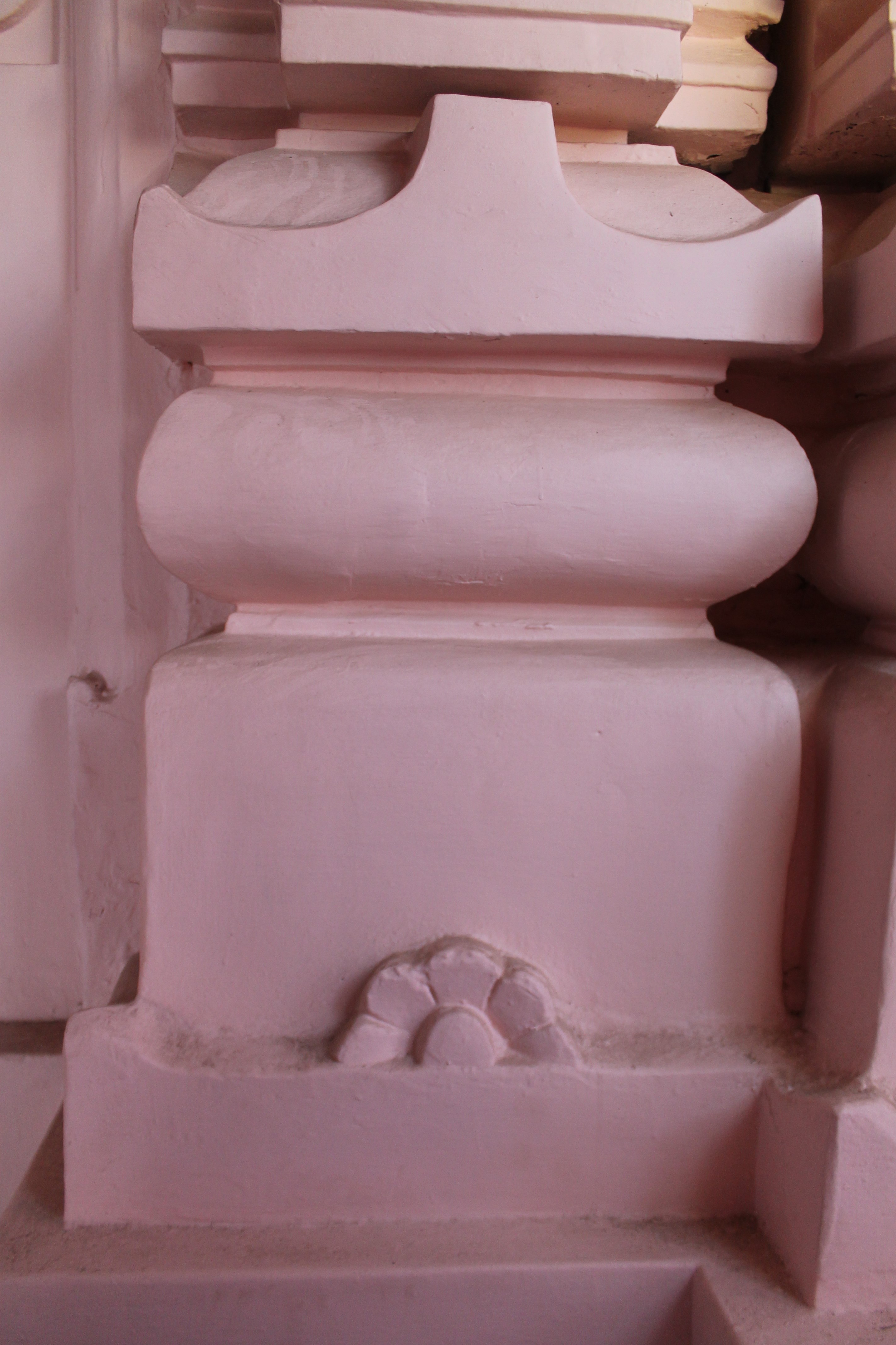 Details of the base mouldings of the Suswani Mata Temple. Four mouldings of the vedibandha (basal mouldings) are visible- from bottom to top, khura (hoof), kumbha (pot), kalasha (pitcher) and kapotapalika (cyma recta). There are floral motifs on the front face of the kumbha moulding.
