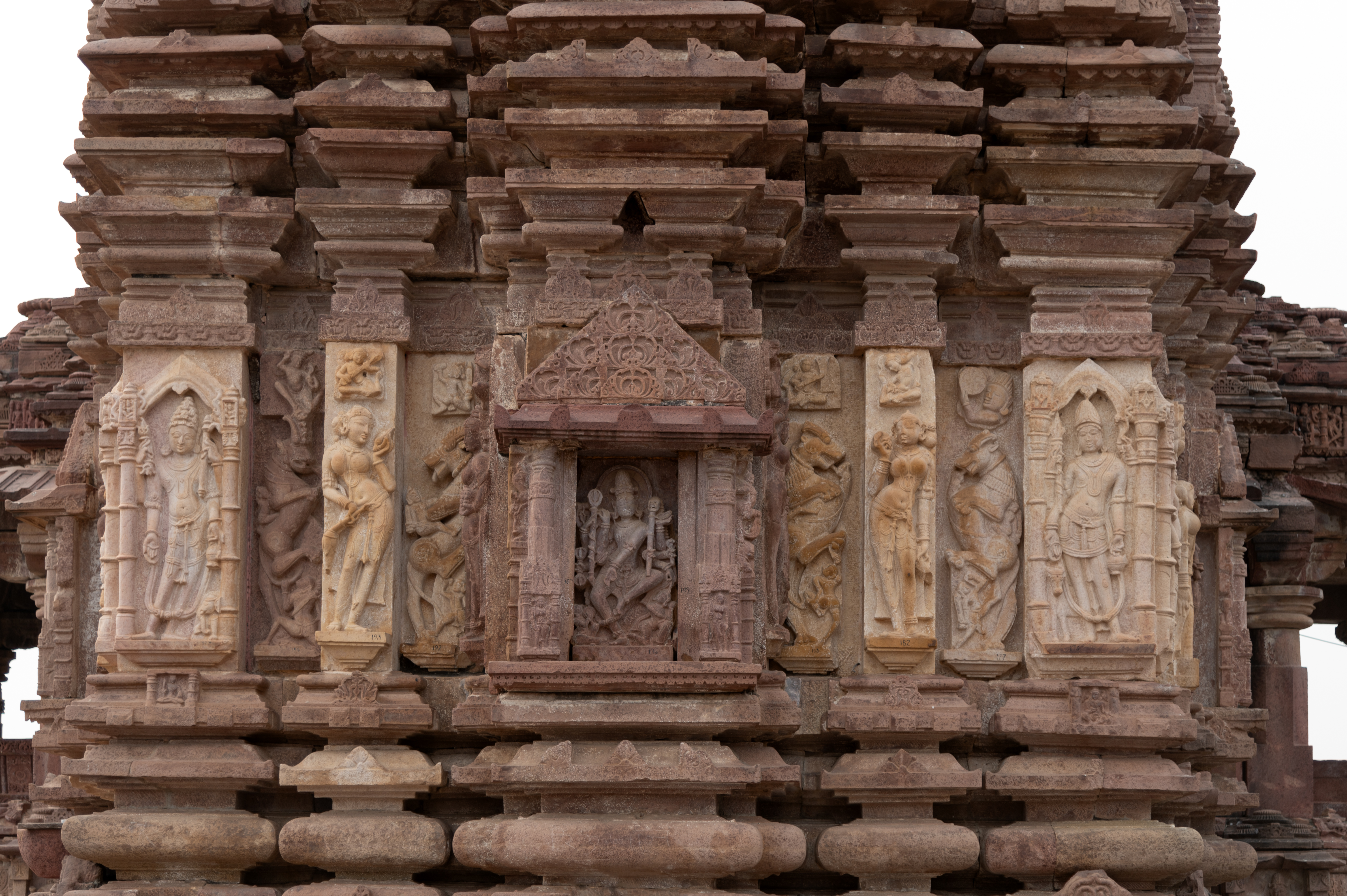 The east-facing jangha (wall) of the Mahanaleshwar Temple has a similar scheme to the details on the north-facing one. The bhadra (central projection) has a Natesha icon; the slender intermediary projections have surasundaris (celestial damsels); and the corner projections have dikapalas (gods of cardinal directions). Each of these projections of the jangha has four kapotali (cyma recta)-like mouldings above them and similar slender horizontal mouldings below. The difference is that the stone material of the intermediary and corner projections is noteworthy.