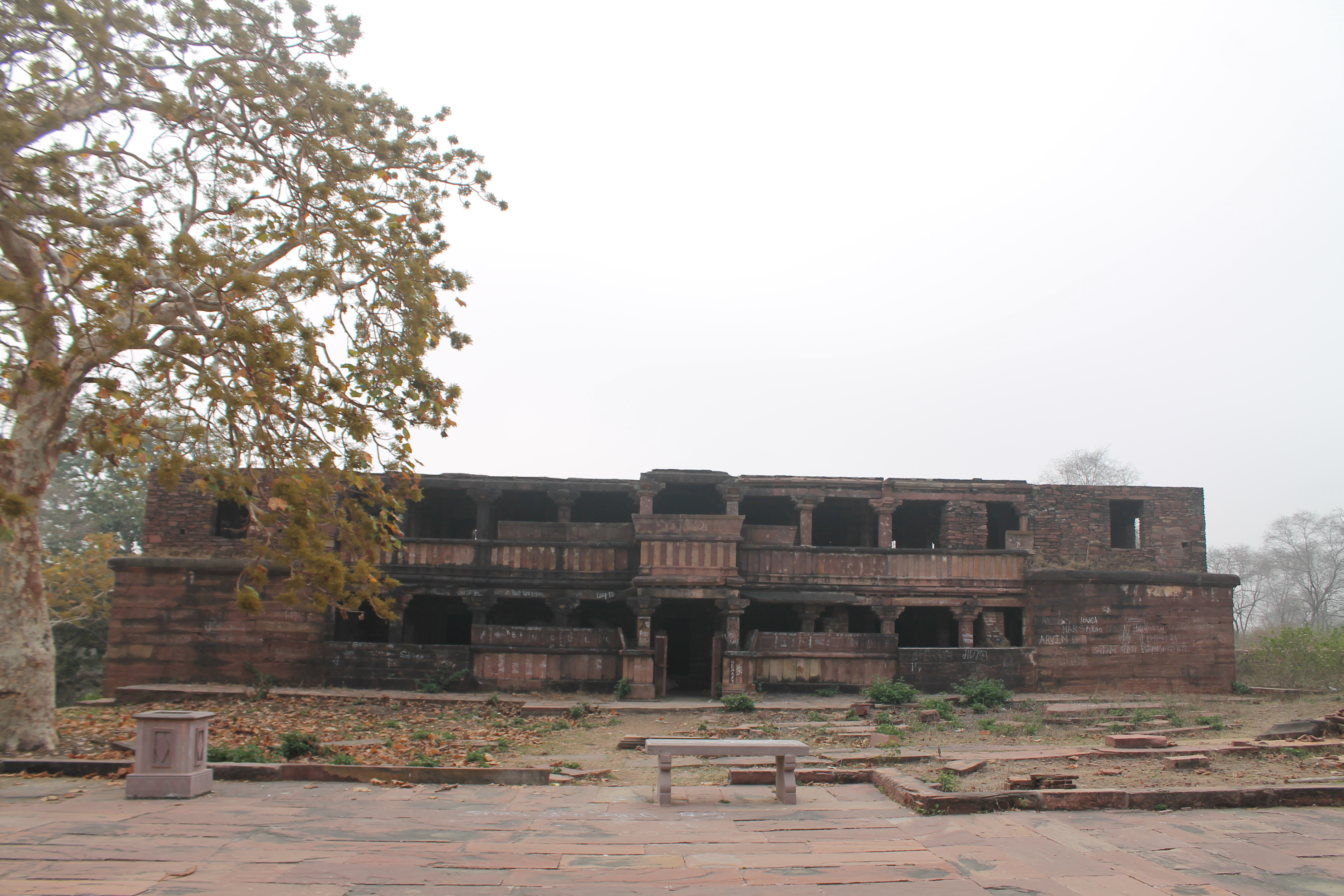 Image 5: Seen here is the north-facing façade of the residential building, a Shaiva matha from the Suhaveshwar temple complex. It is a two-storeyed structure with several rooms on both floors. The matha is in ruinous condition. The exterior stone of the matha is broken in several places.