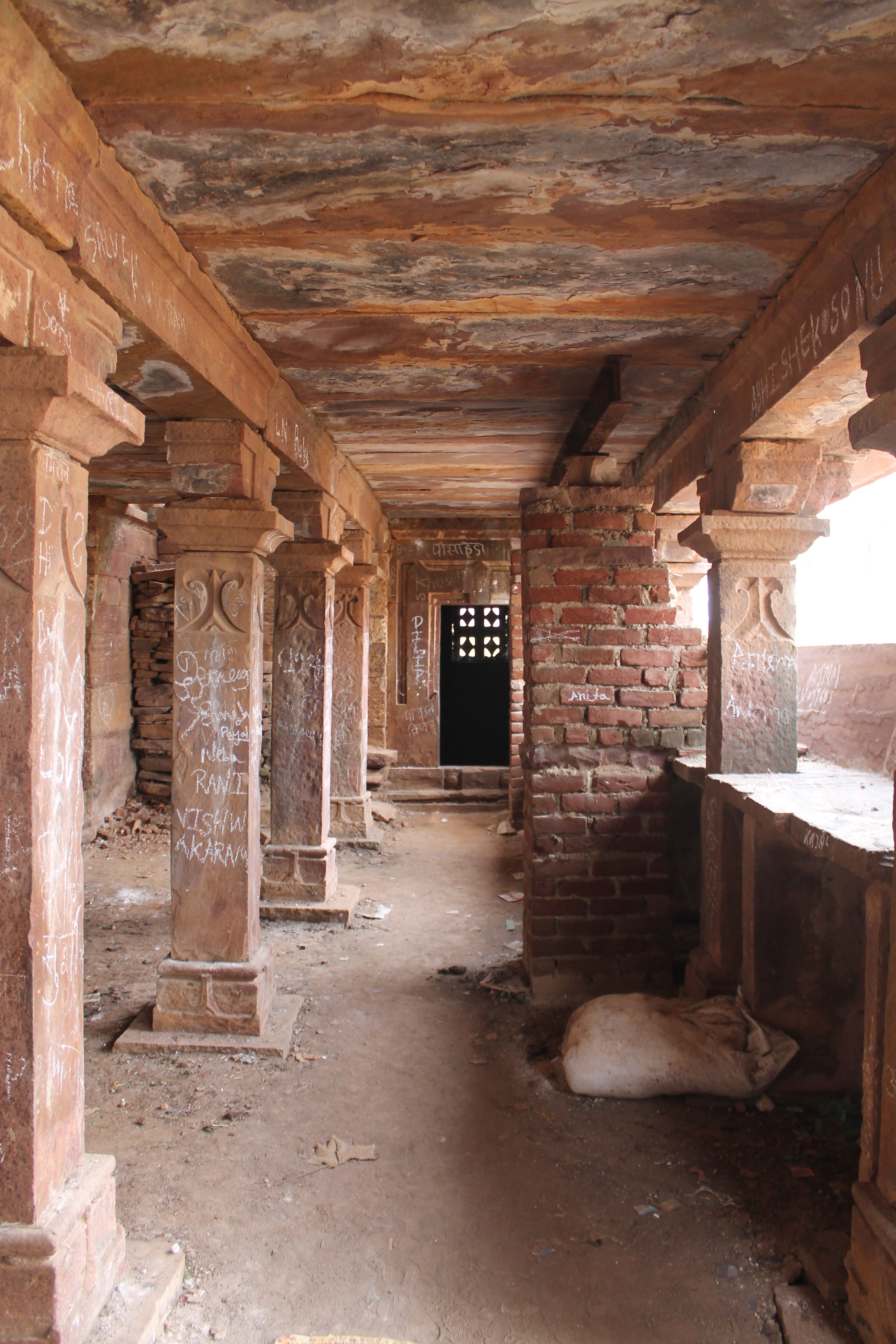 The ground floor of the Suhaveshwar Temple's matha (monastic or residential building) has a long colonnade on its front side. There are four pillars in the colonnade that flank the main entrance. These pillars are equidistant from one another. At the end of the colonnade there is a small cell.