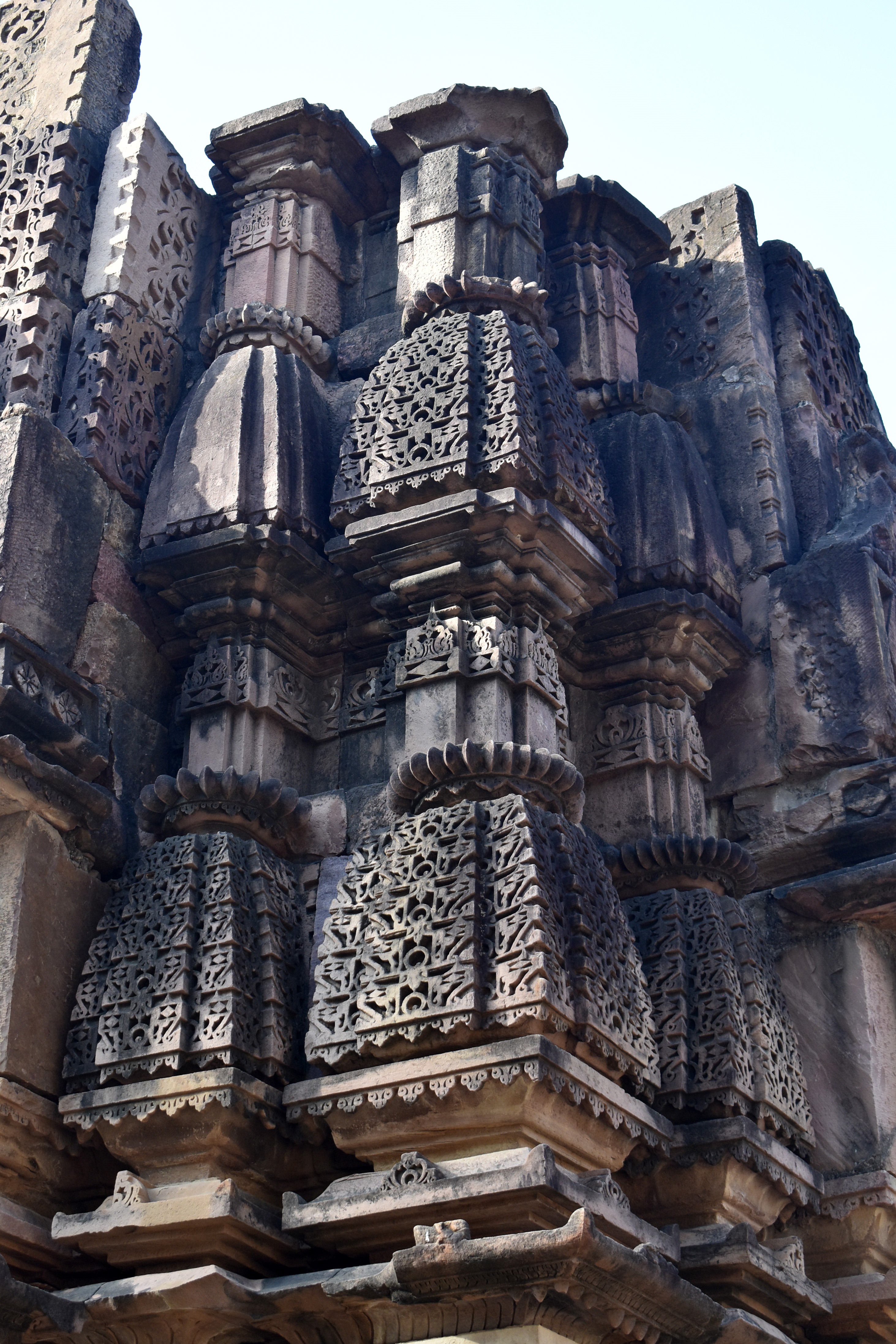 The kutastambhas (vertical rows of miniature shikharas or spires) on the surviving sections of the shikhara (superstructure) have square-shaped stambhas (pillars) with decorative motifs. Positioned above these stambhas are the kutas (miniature shikharas), with the lower ones featuring intricately carved chaitya arch (dormer window) jali, while the upper ones remain plain. These kutastambhas are distinctive elements of the Bhumija shikhara.