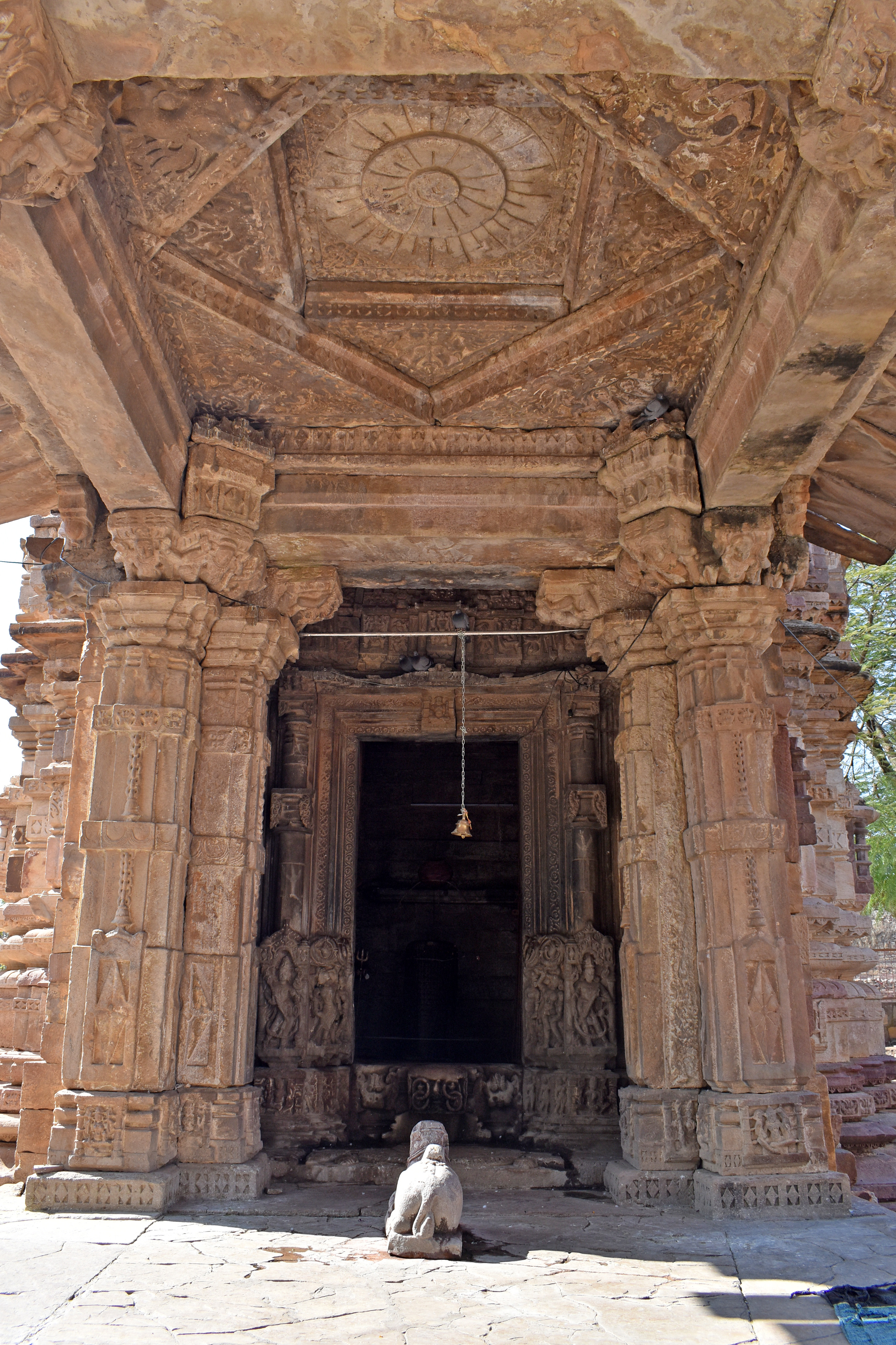 Image 6: The pilasters at the back of the mandapa (pillared hall) are elegantly adorned with bell and chain motifs. At the centre of the mandapa, a stone sculpture of Nandi (Shiva’s bull) is placed, facing towards the garbhagriha (sanctum sanctorum).