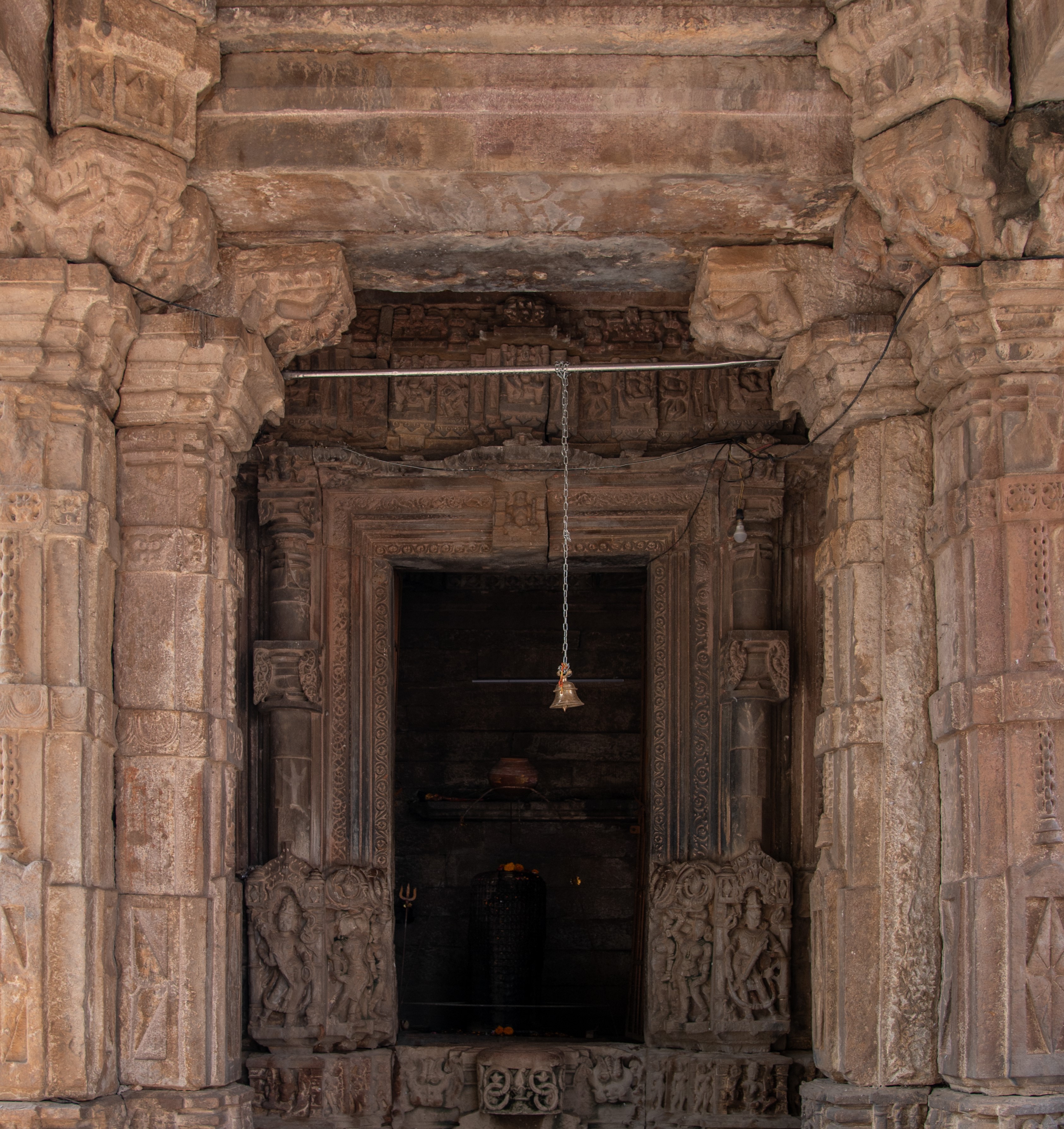 Image 8: The antarala (vestibule) of the Hazareshwar Temple is shallow and minimalistic, with no decoration except for the floor. Here, a moonstone serves as a stepping stone, leading to the threshold of the garbhagriha (sanctum sanctorum).