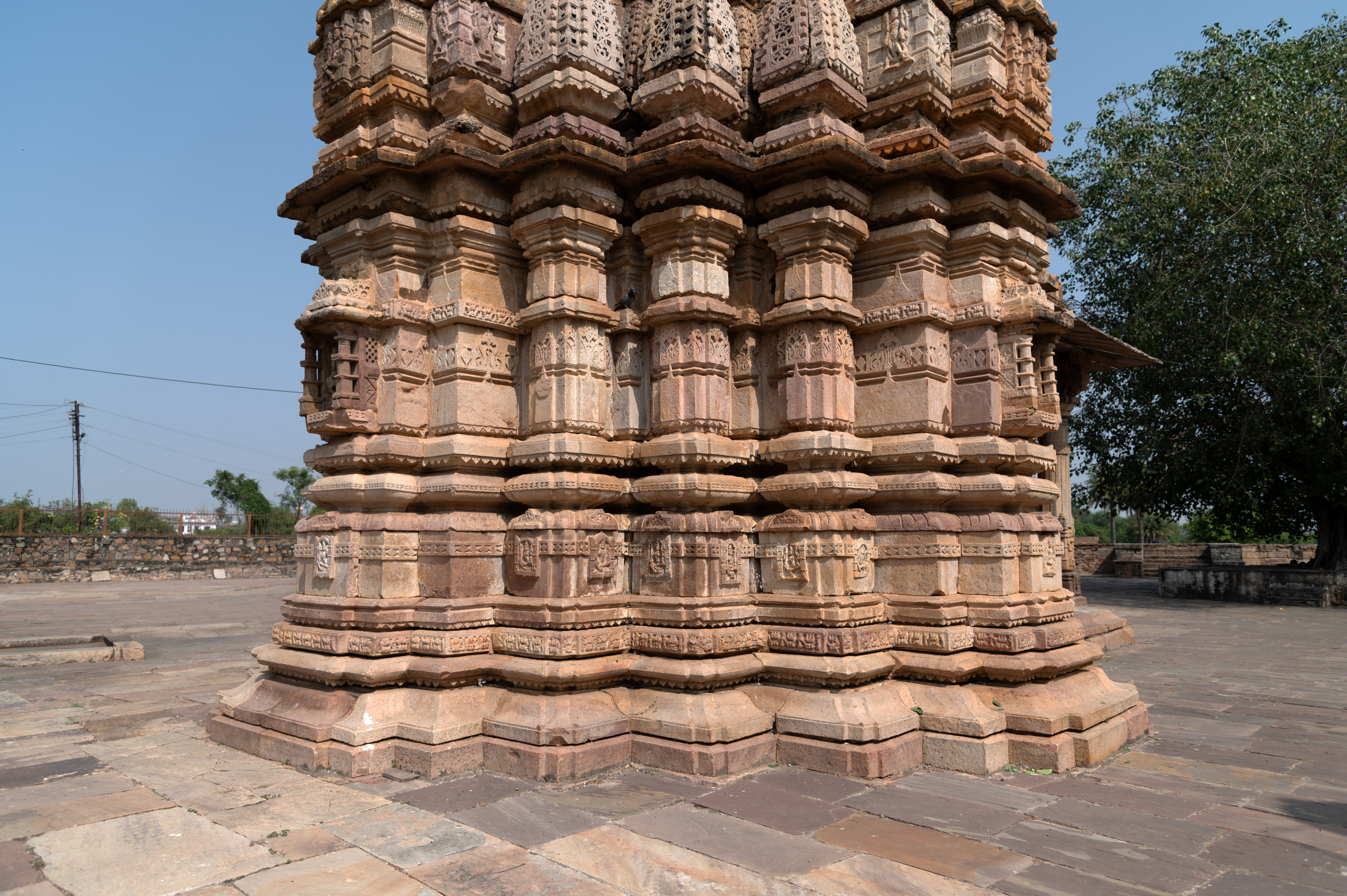 Image 16: The exterior wall of the garbhagriha (sanctum sanctorum) of the Hazareshwar Temple presents a blend of bhadras (central projections) and stambhas (pillars), creating a captivating visual tapestry. The bhadras, intricately carved on the cardinal directions, serve as focal points of the structure’s architectural elegance, while the stambhas fill the spaces in between.