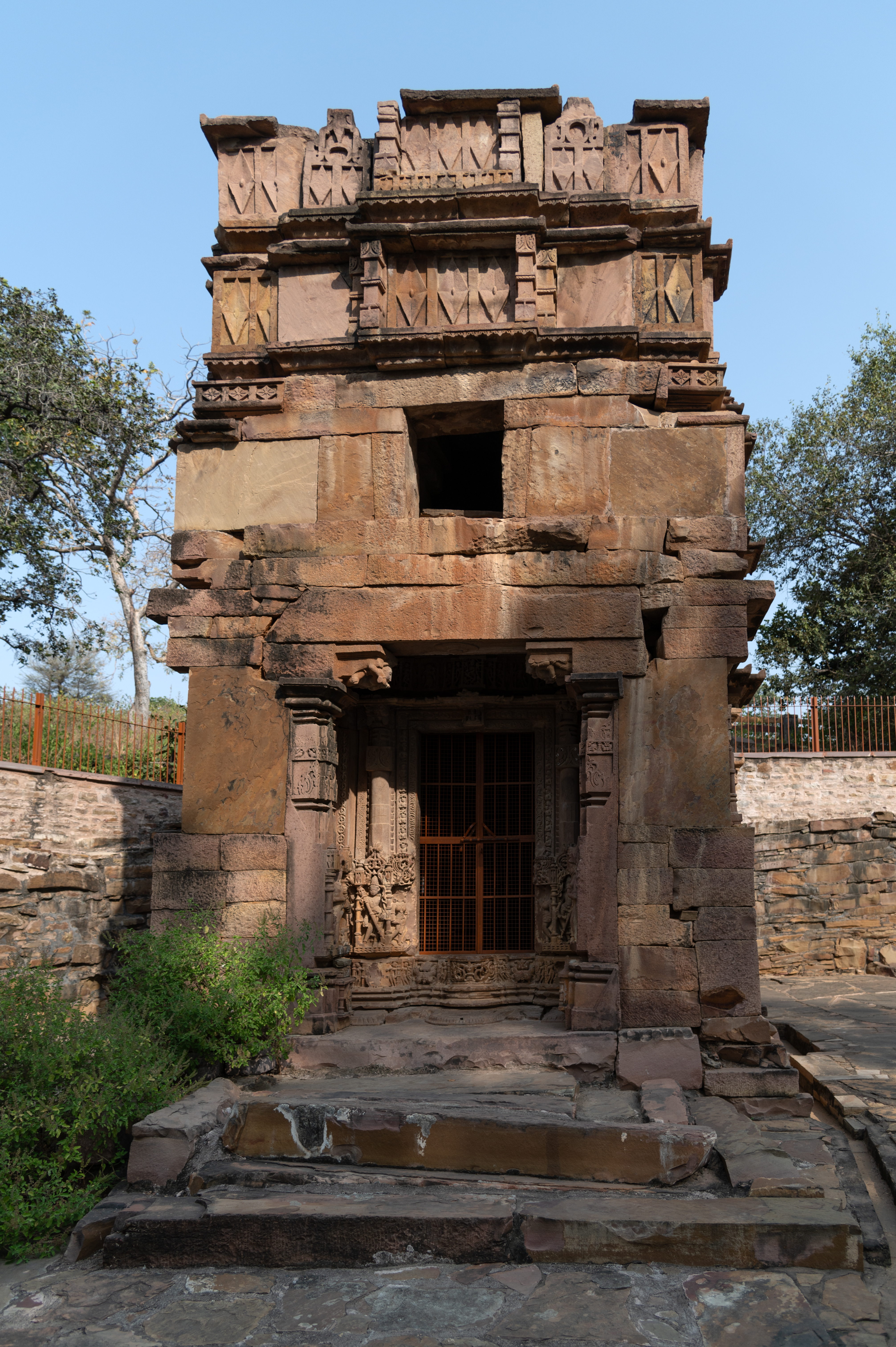 Image 4: The west-facing Shiva temple now consists of a garbhagriha (sanctum sanctorum) and an antarala (vestibule or antechamber), with the mandapa (pillared hall) having fallen into disrepair. The upper part of the shikhara (superstructure) has been affected by damage. Stylistically, the temple dates back to the 12th century CE.