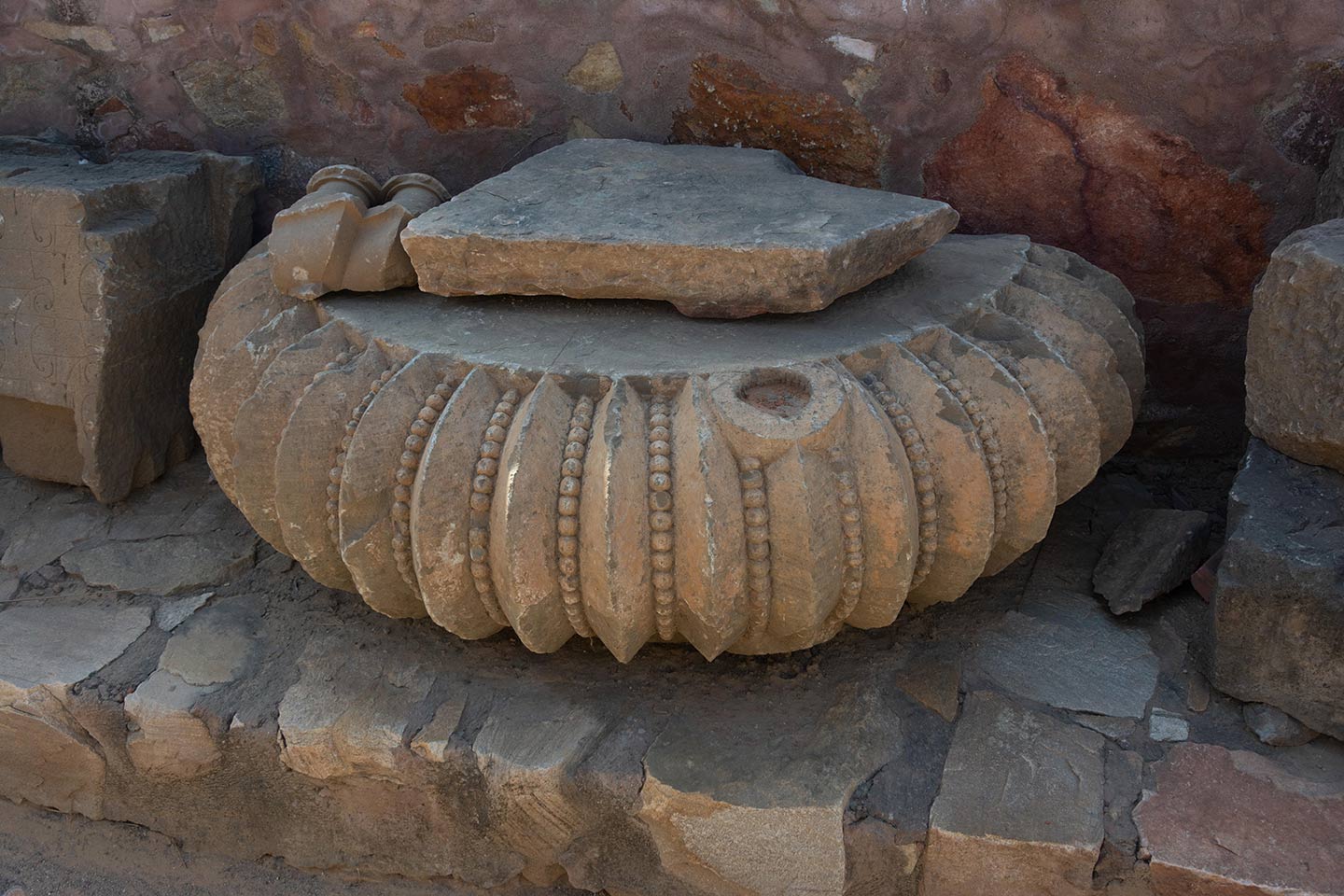 Damaged amalaka fragments are now kept along the south boundary wall, along with other broken fragments recovered from the original temple's debris.