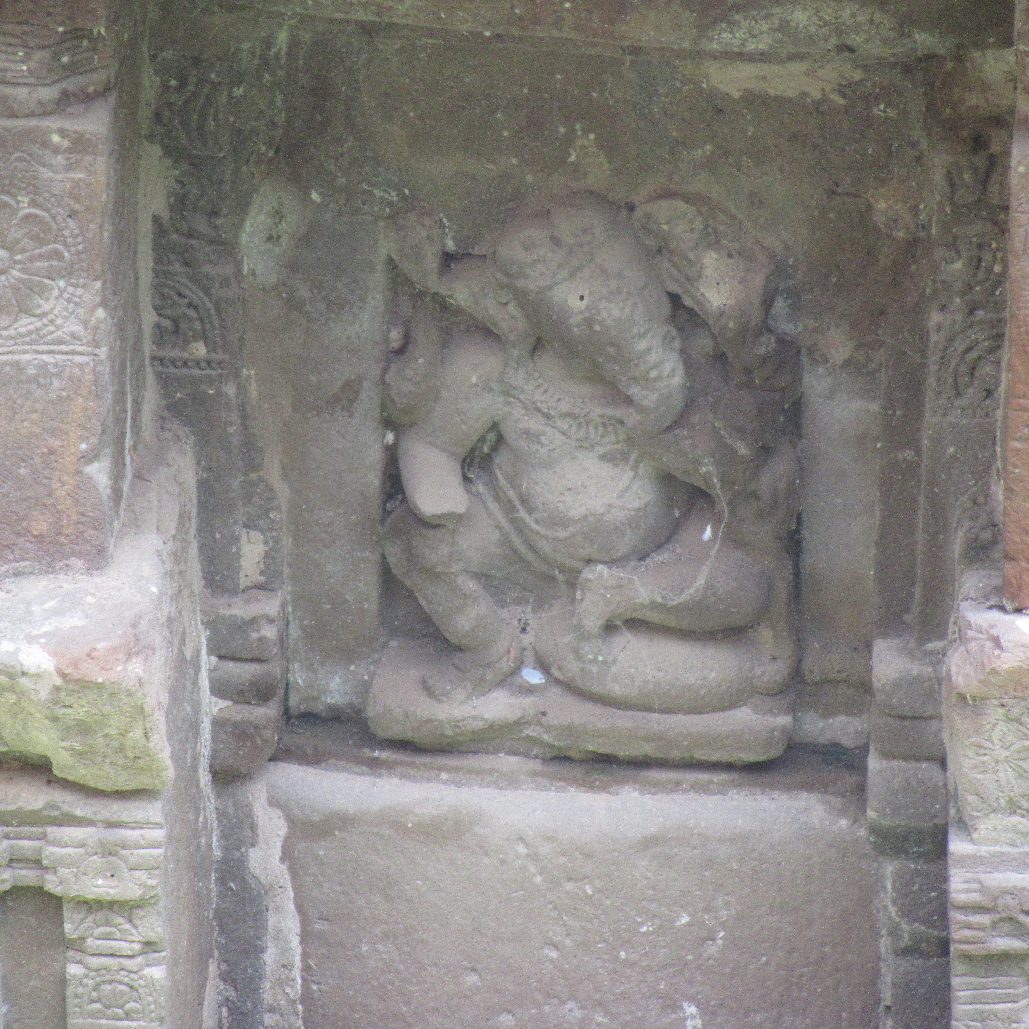 Image 3: A four-armed male deity seated on a cushion in lalitasana. It is stylistically similar to the multiple Ganesha images recovered from the Harshatmata Temple.