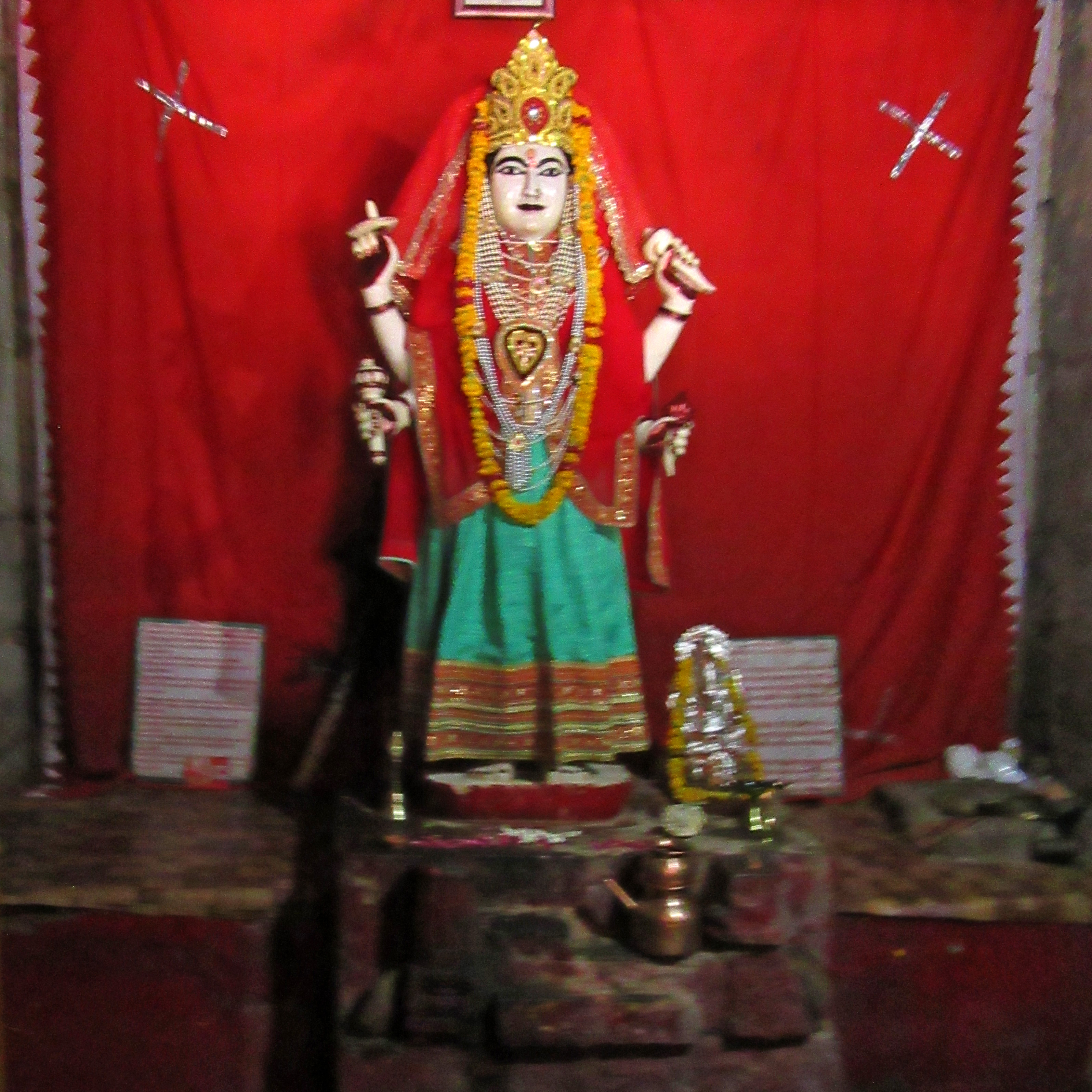 Image 9: Standing in the samabhanga pose, a four-armed female deity holds a mace, conch, flower, and chakra. She is venerated in the sanctum for daily worship.